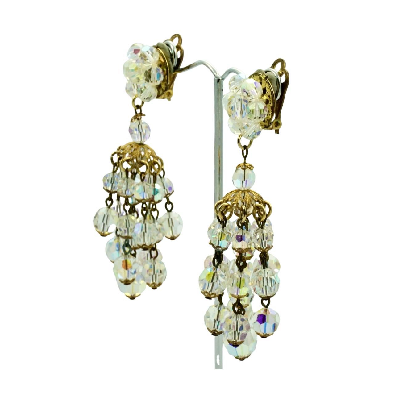Fabulous gold plated chandelier clip on earrings, featuring nine strands of faceted aurora borealis beads. Each bead is finished with a filligree cap. Measuring length 7.9 cm / 3.1 inches. There is wear to the gold plating. The tops have been