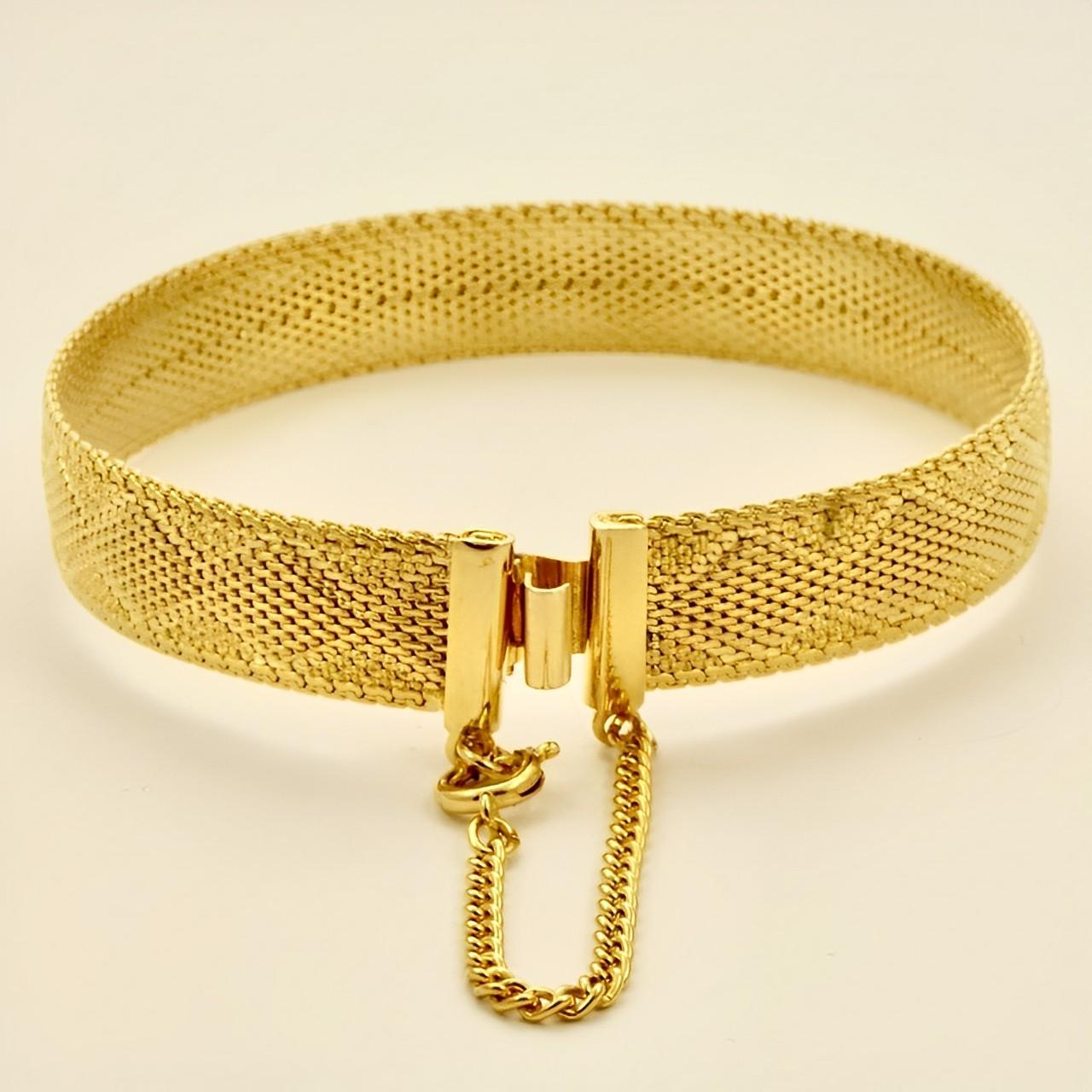 Beautiful gold plated Egyptian Revival mesh bracelet, featuring a lovely diamond design, and safety chain. Measuring length approximately 18.2 cm / 7.1 inches by width 1.05 cm / .4 inch. The bracelet is in very good condition.

This stylish bracelet