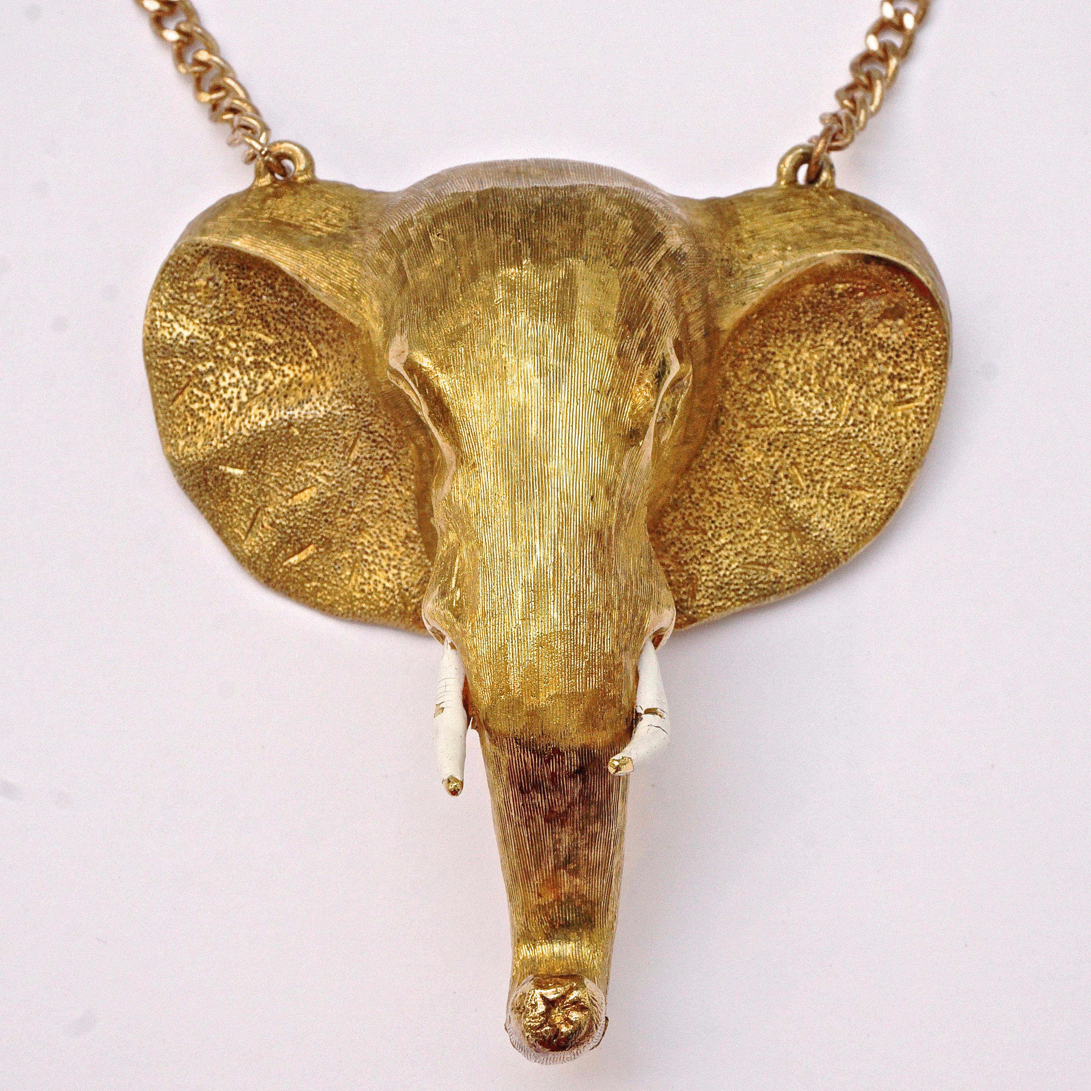 Fabulous gold plated elephant head pendant chain necklace, the elephant is also a brooch with a quality bar pin. The curb link chain may not be the original, and measures 58cm / 22.8 inches. The heavy elephant head is textured, and has clear crystal
