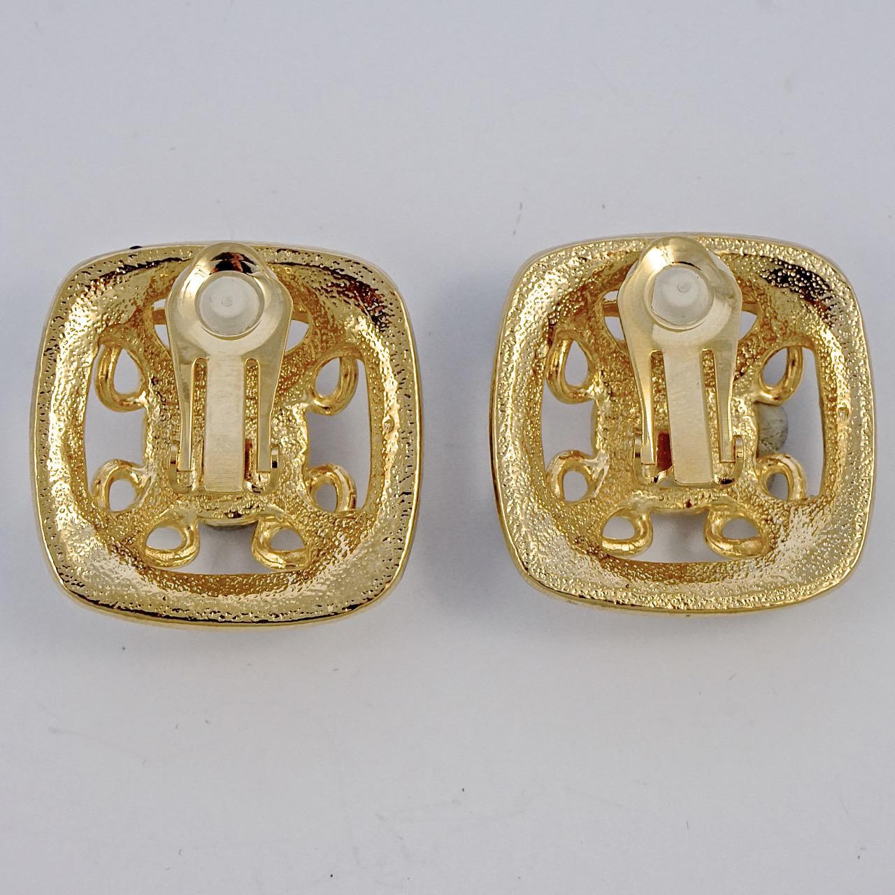 Gold plated clip on earrings with faux pearls and a lovely blue and green enamel edging. Measuring 3cm / 1.2 inches square. The earrings are in very good condition.

This is a pair of stylish vintage earrings from the 1980s.
