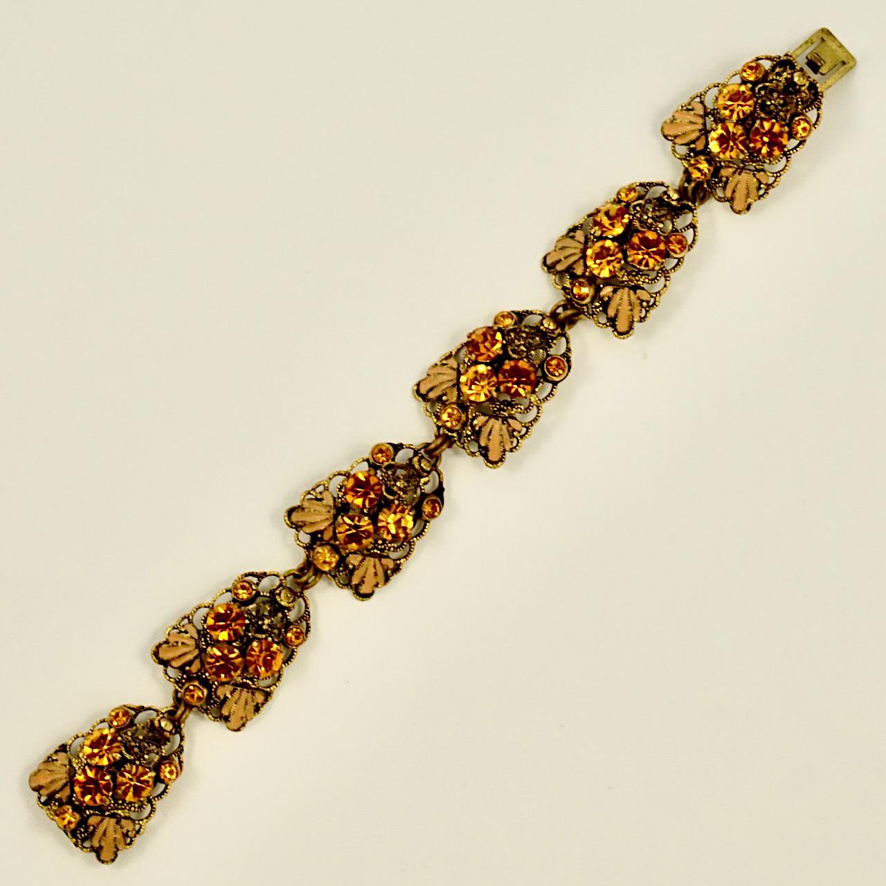 Beautiful gold plated filigree earrings and bracelet set, featuring citrine rhinestones. The pieces are finished with caramel and black enamel. The bracelet is length 19 cm / 7.4 inches by width 2 cm / .78 inch. The earrings are length 5.5 cm / 2.1