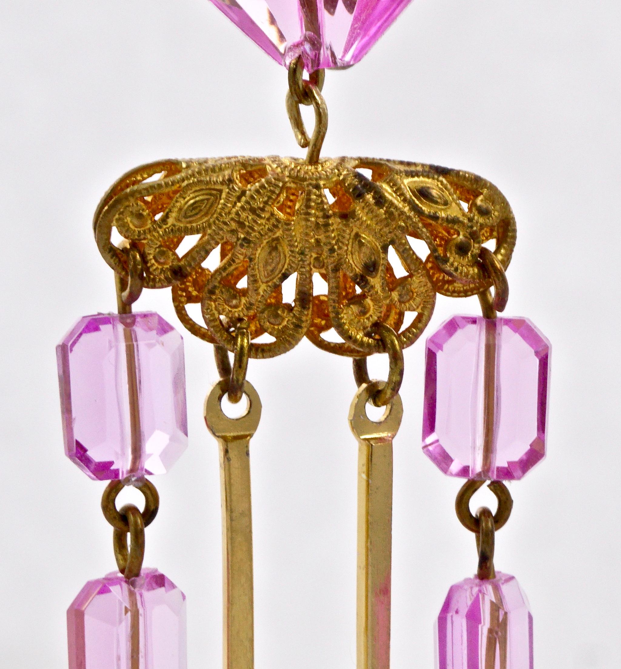 Fabulous gold plated filigree clip on chandelier earrings, featuring four strands of pink plastic beads. Measuring length 9.7cm / 3.8 inches. The earrings are light to wear. There is some wear to the gold plating.

These are stunning vintage