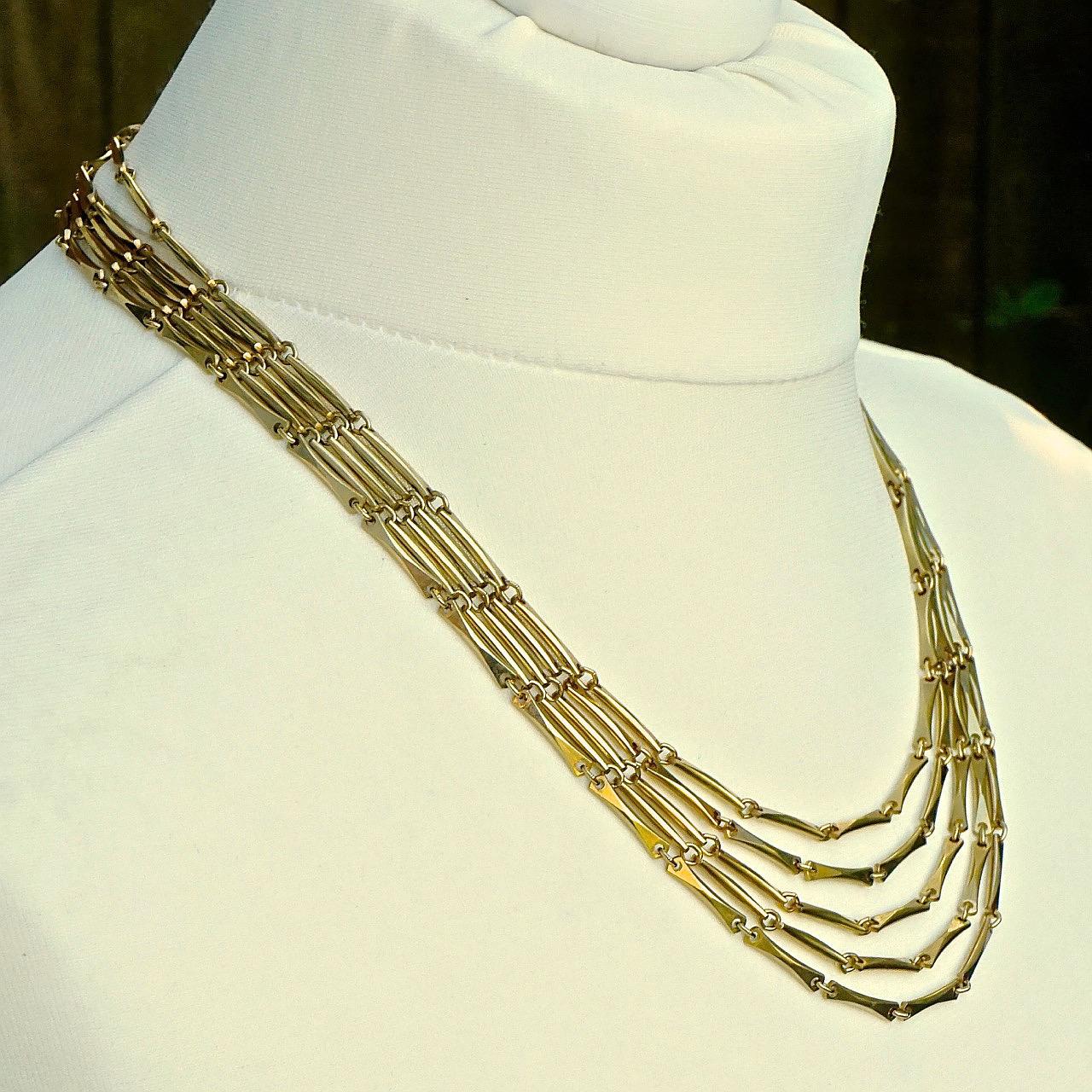 Wunderschöne vergoldete fünfsträngige Halskette mit einer Stab- und Gliederkette und einem strukturierten Verschluss. Der kürzeste Strang hat eine Länge von 49,5 cm / 19,5 Zoll. Die Halskette ist in sehr gutem Zustand.

Dies ist eine schöne