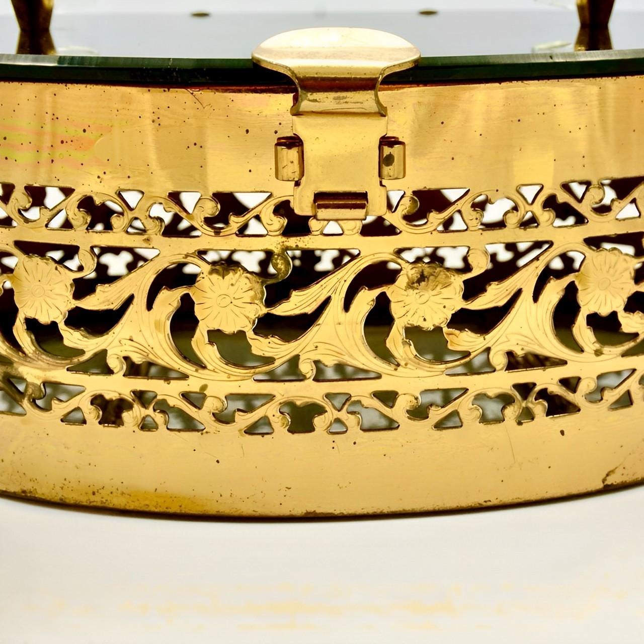 Lovely gold plated flower filigree handbag, with a black lucite lid and clear lucite handle and bottom. Measuring width 18.9 cm / 7.4 inches by height 7.4 cm / 2.9 inches. The handle drop is 10.8 cm / 4.25 inches. The bag has scratching as expected,