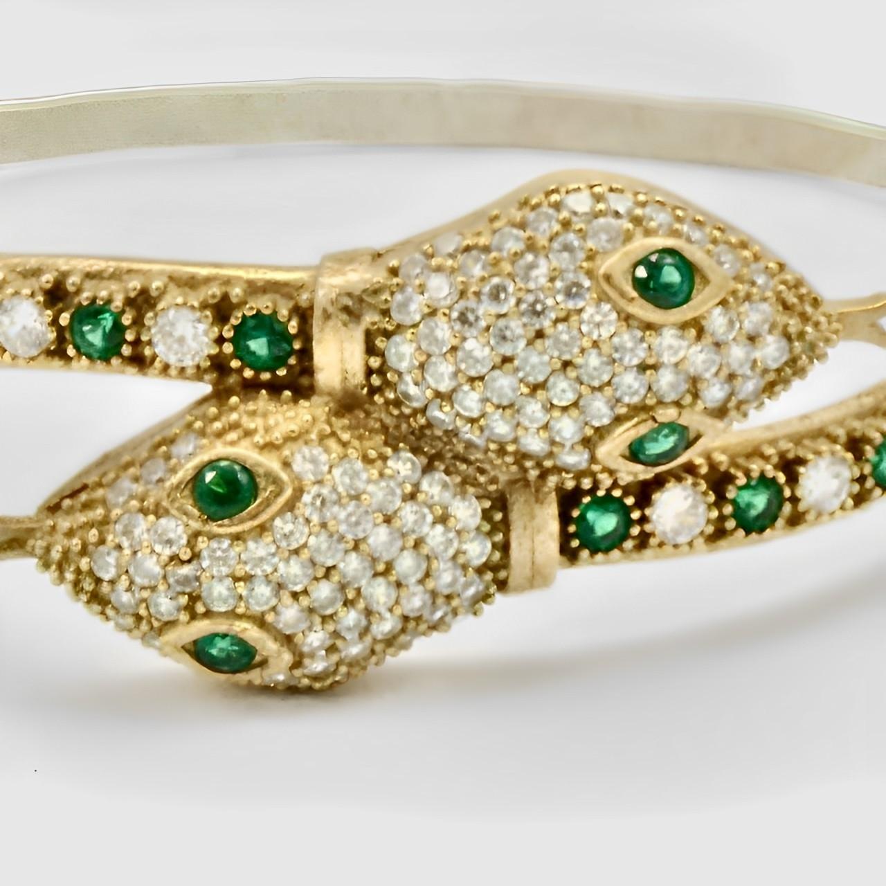 Fabulous gold plated snake bracelet set with green and clear rhinestones. Measuring inside length diameter 5.8 cm / 2.28 inches by width diameter 4 cm / 1.57 inch. It appears that the silver tone ornate back is a later addition.

This is a beautiful