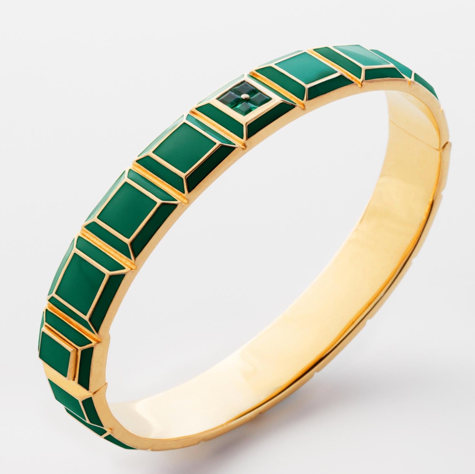 Gold-Plated Enamel Carousel Bracelet features a Yellow Gold Plated Silver bracelet with green enamel and emeralds, along with a clasp closure that secures the bracelet onto the wearer's wrist. 
Yellow Gold Plated Silver, Green Enamel, Emeralds