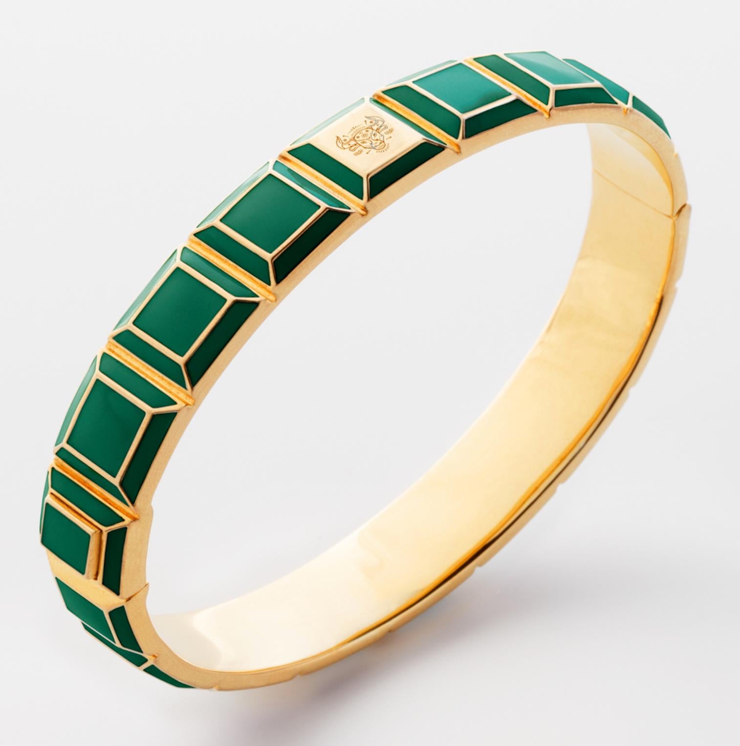 Gold-Plated Enamel Carousel Bracelet features a Yellow Gold Plated Silver bracelet with green enamel and Taurus Zodiac engraving, along with a clasp closure that secures the bracelet onto the wearer's wrist. 
Yellow Gold Plated Silver, Green