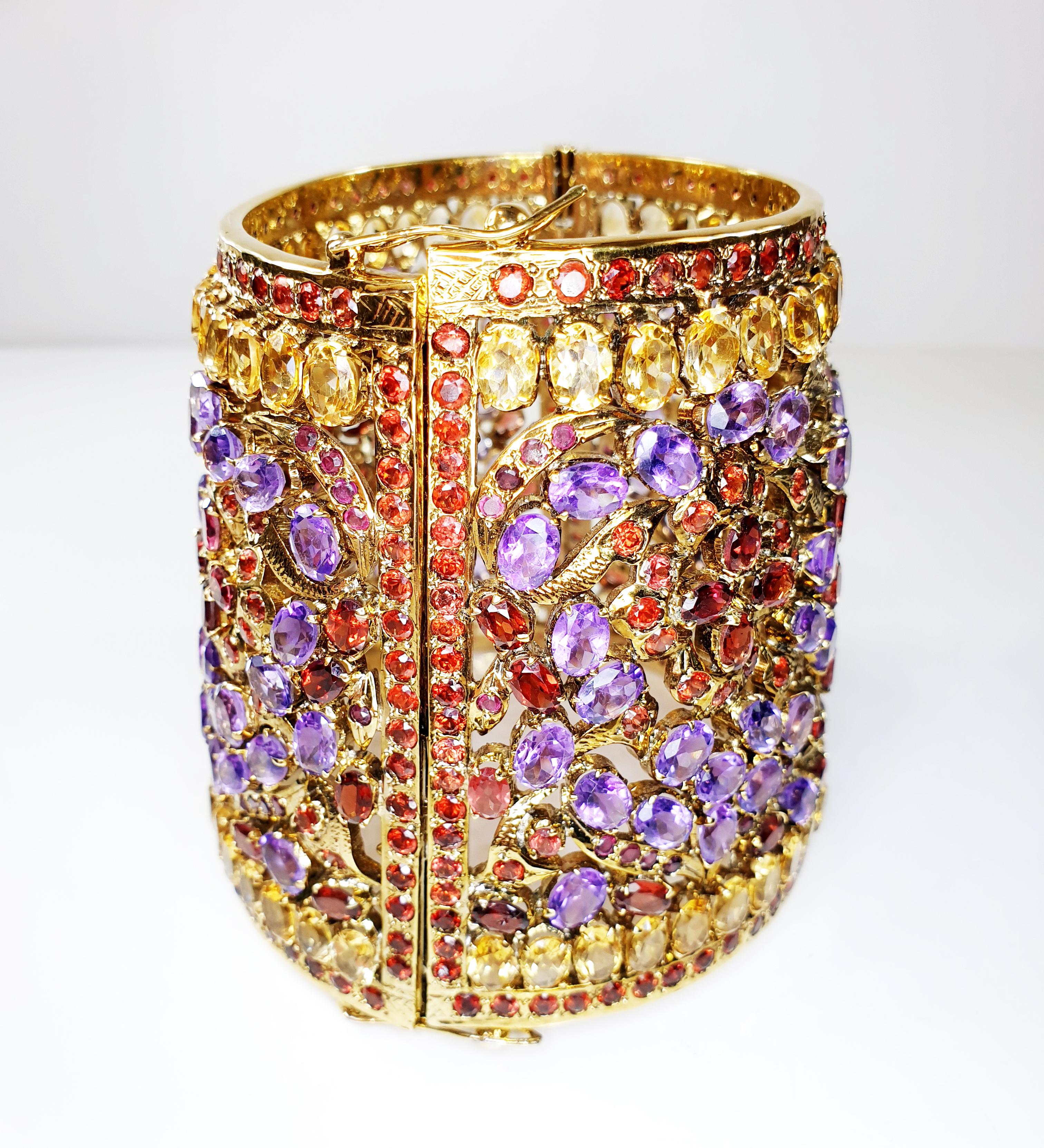 18k Gold plated Indian Cuff Bracelet with amethysts, citrines and granates 
A superb anglo-indian bracelet 
A solid silver mounting  gold plated finish that holds 4 gardens divided by a panelling of grantes, leaves of citrines and flowers of