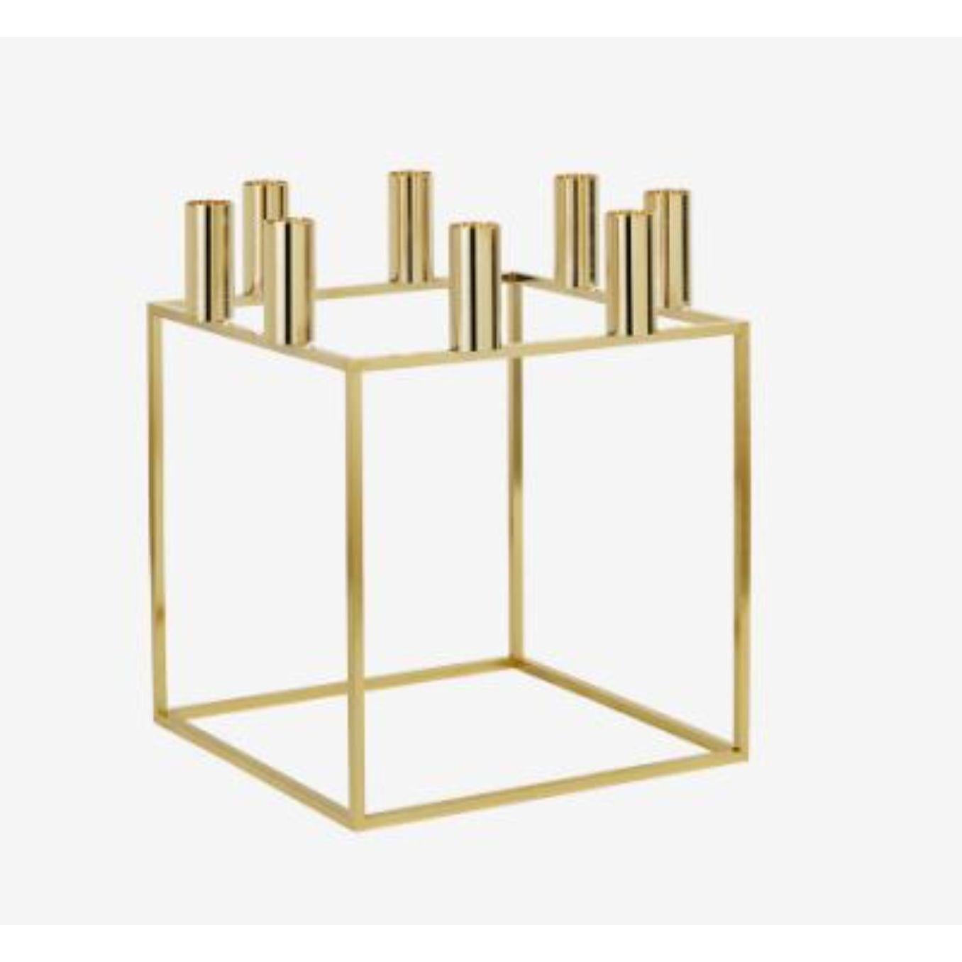 Gold plated kubus 8 candle holder by Lassen
Dimensions: D 23 x W 23 x H 29 cm 
Materials: Metal 
Also available in different dimensions. 
Weight: 1.50 Kg

With a sharp sense of contemporary Functionalist style, Mogens Lassen designed the