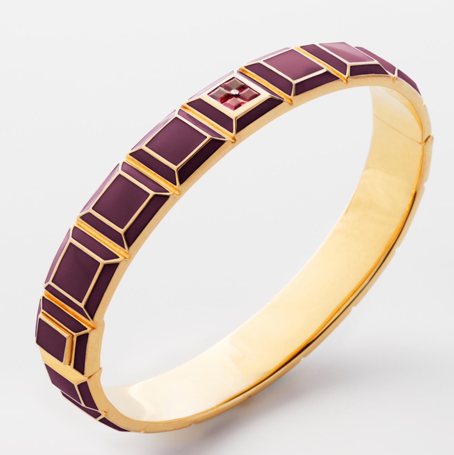 Gold-Plated Enamel Carousel Bracelet features a Yellow Gold Plated Silver bracelet with Bordeaux enamel and rubies, along with a clasp closure that secures the bracelet onto the wearer's wrist. 
Yellow Gold Plated Silver, Bordeaux Enamel, Rubies 