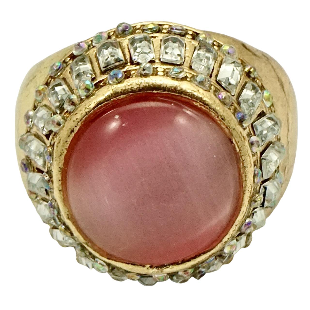 Beautiful gold plated cocktail ring, set with a pink moonglow surrounded by clear baguette and aurora borealis round crystals. Ring size UK Q, US 8. Inside diameter 1.9 cm / .74 inch. The ring is in very good condition.

This glamorous cocktail ring