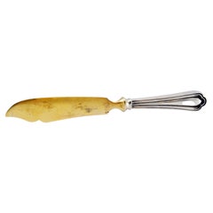 Gold-plated silver cheese knife with grooves along the handle