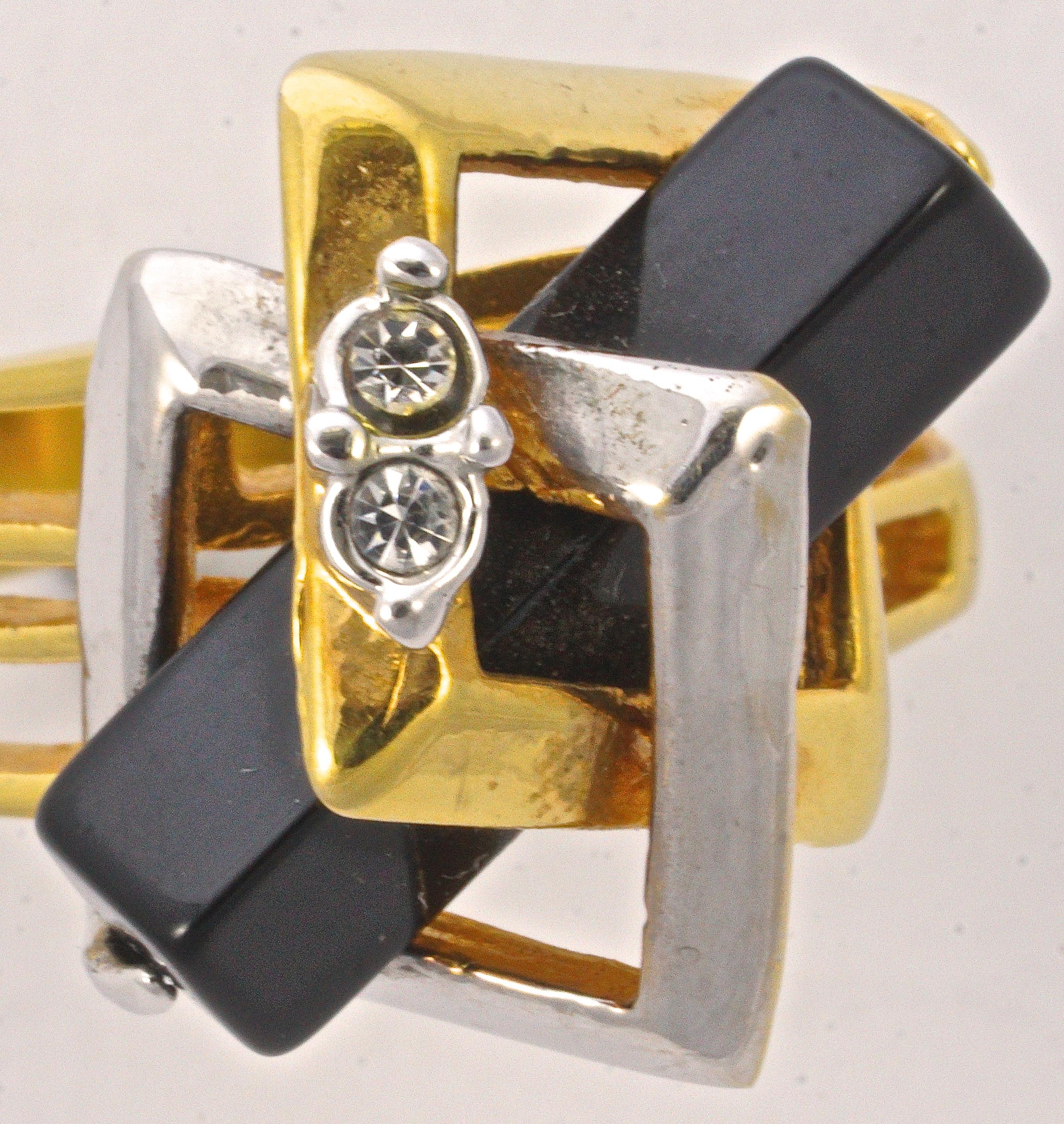 Unusual gold plated ring, decorated with gold and silver plated squares, and featuring a black cuboid and two clear rhinestones. Ring size UK P 1/2, US 7 3/4. The front is approximately 2cm / .79 inch by 2cm / .79 inch, and the setting depth is