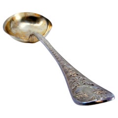 Gold-plated silver sauce spoon with raised handle and monogram card