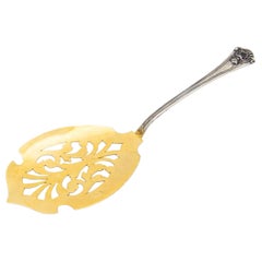 Gold-plated silver spatula for cakes with reliefs