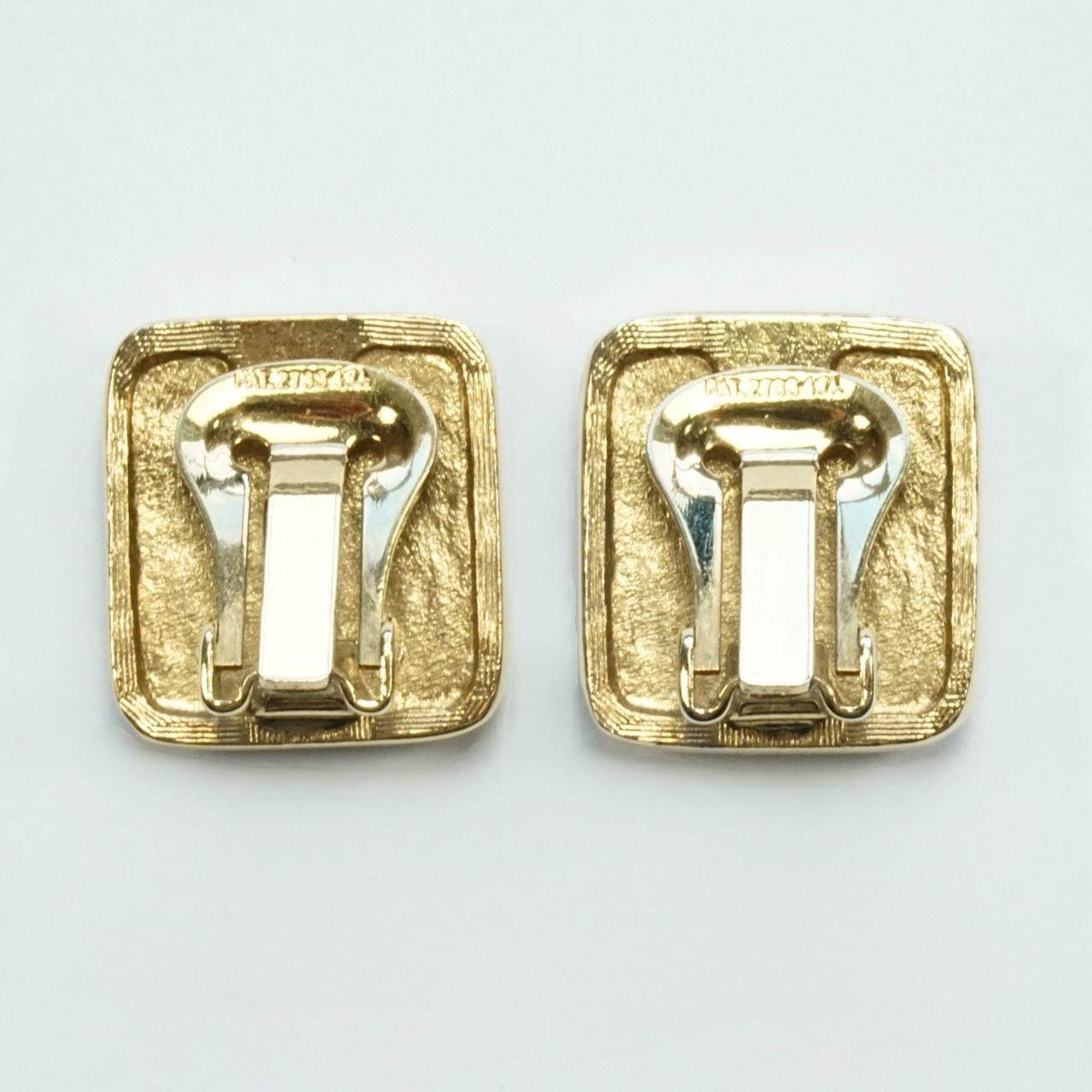 Beautiful gold plated square clip on earrings, embellished with small clear rhinestones set in silver plate, surrounding a central large square rhinestone. Measuring 1.8 cm / .7 inch by 1.7 cm / .67 inch.

These quality vintage earrings would add