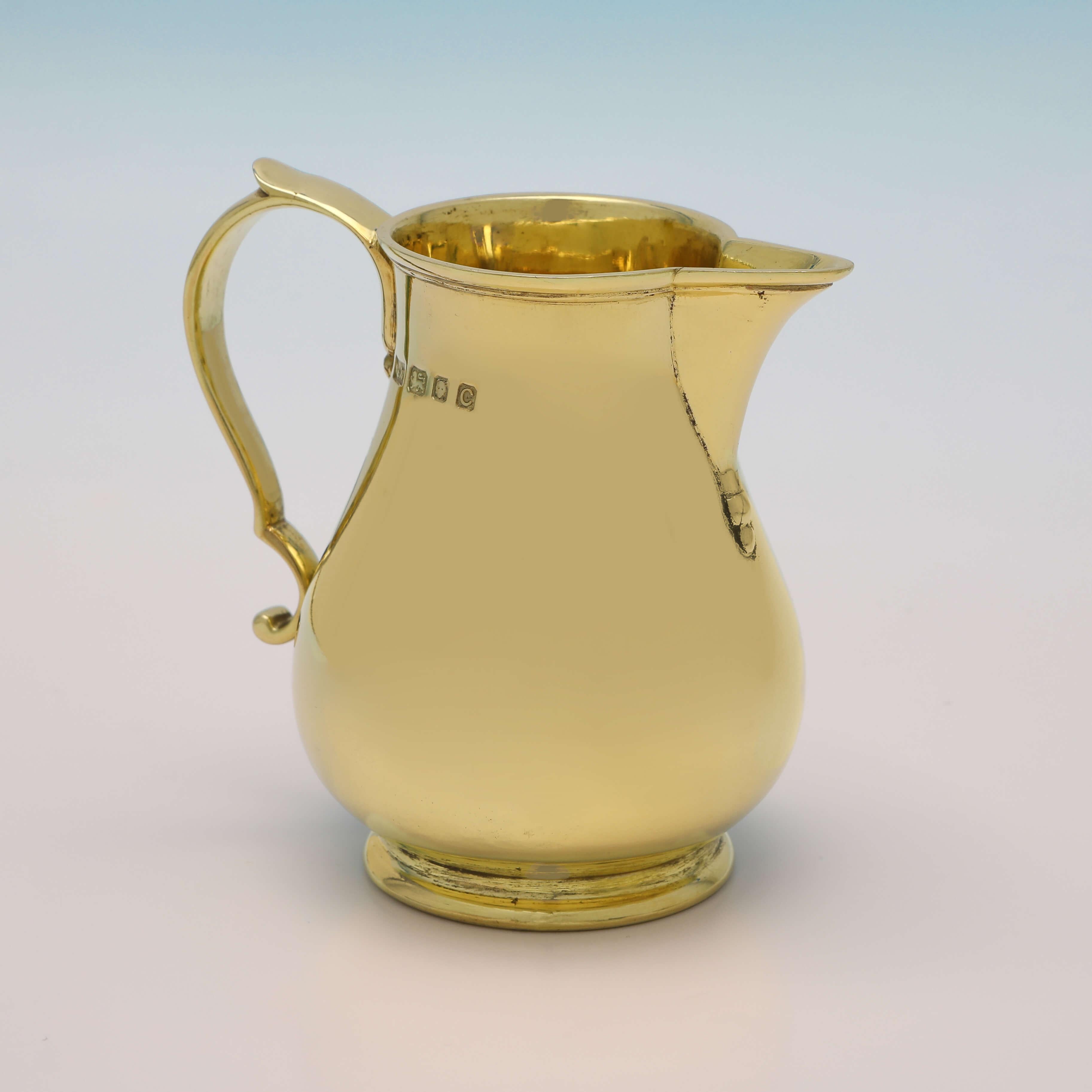 Hallmarked in London in 1938 by Walter H. Wilson Ltd., this handsome, Sterling Silver Cream Jug, is in the 'Sparrow beak' style, and is gold plated. The cream jug measures 3