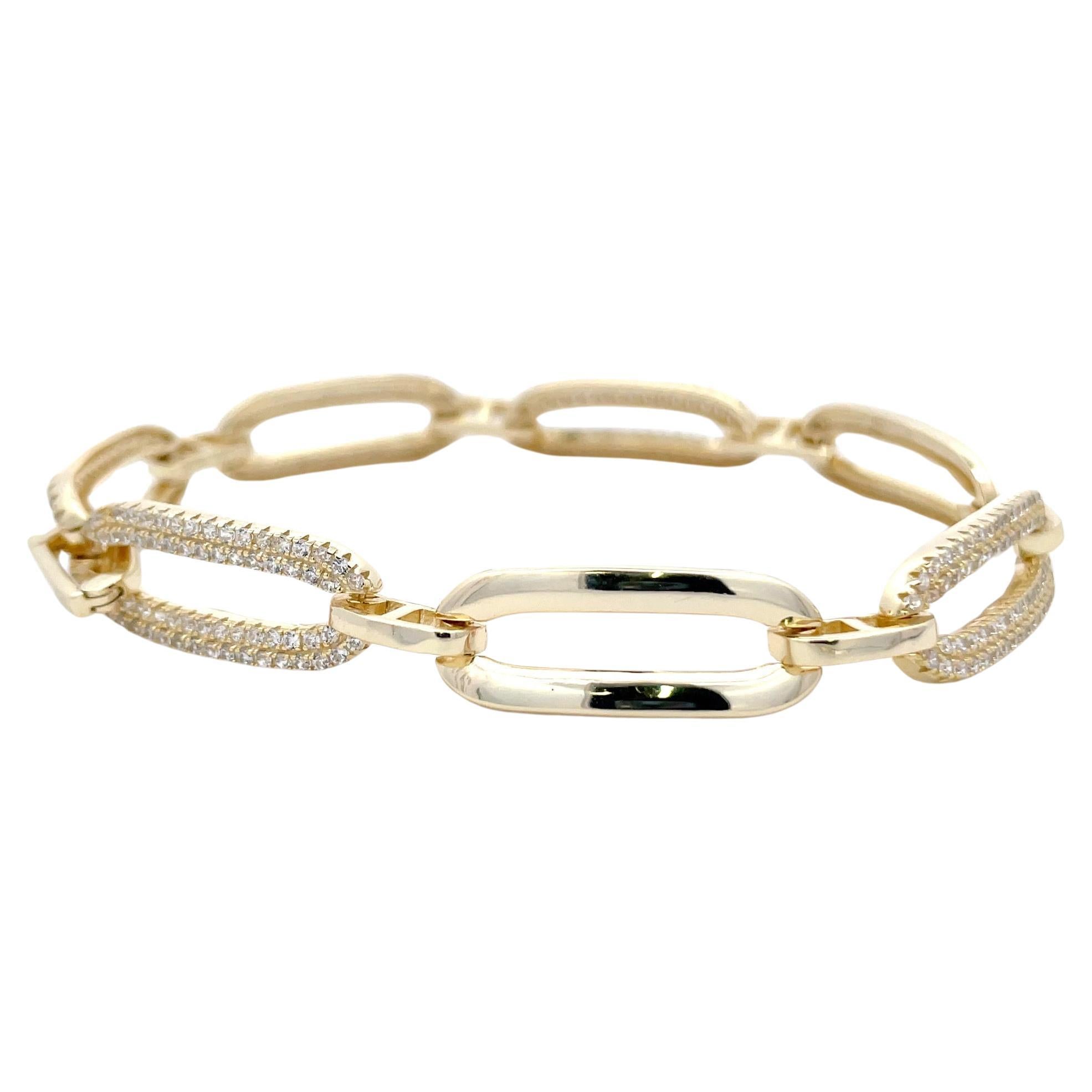 Gold plated sterling silver bracelet featuring alternating high polished and cubic zirconia links with a fold-over clasp.  
Great quality, will not tarnish!