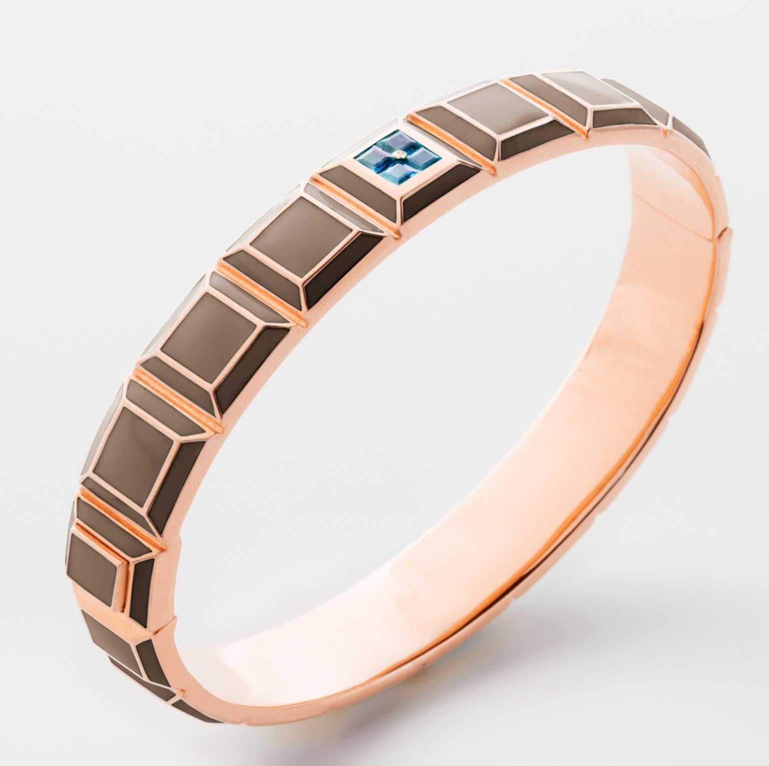 Gold-Plated Enamel Carousel Bracelet features a Rose Gold-Plated Silver bracelet with Taupe Enamel and Blue Topaz stones, along with a clasp closure that secures the bracelet onto the wearer's wrist. 
Yellow Gold Plated Silver, Taupe Enamel, Blue