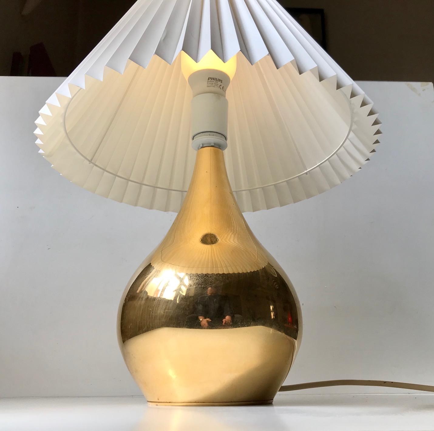 A rare rather monumental 24 carat gold plated table light in the shape of a Tear Drop. Hence its name. It was designed and manufactured during the 1960s by Hugo Asmussen in Denmark. The base/foot of the light shows ware and patina due to patination