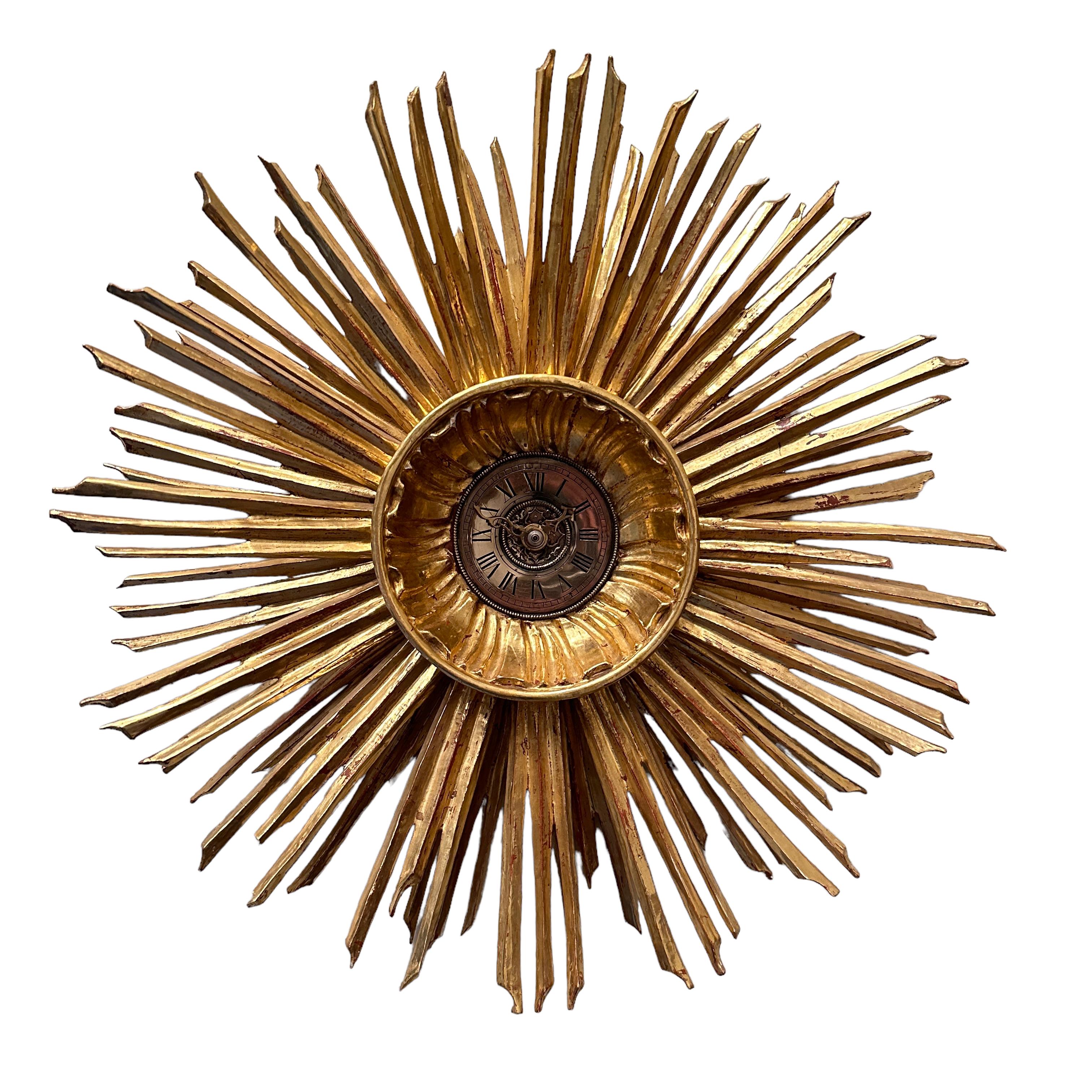 Stunning original 1970s sunburst starburst wall clock. Featuring beautiful wood and gold plated sunburst surrounding illustrating perfectly the mood of the decade. The clock has the particularity of having a open face so hands can be accessed from