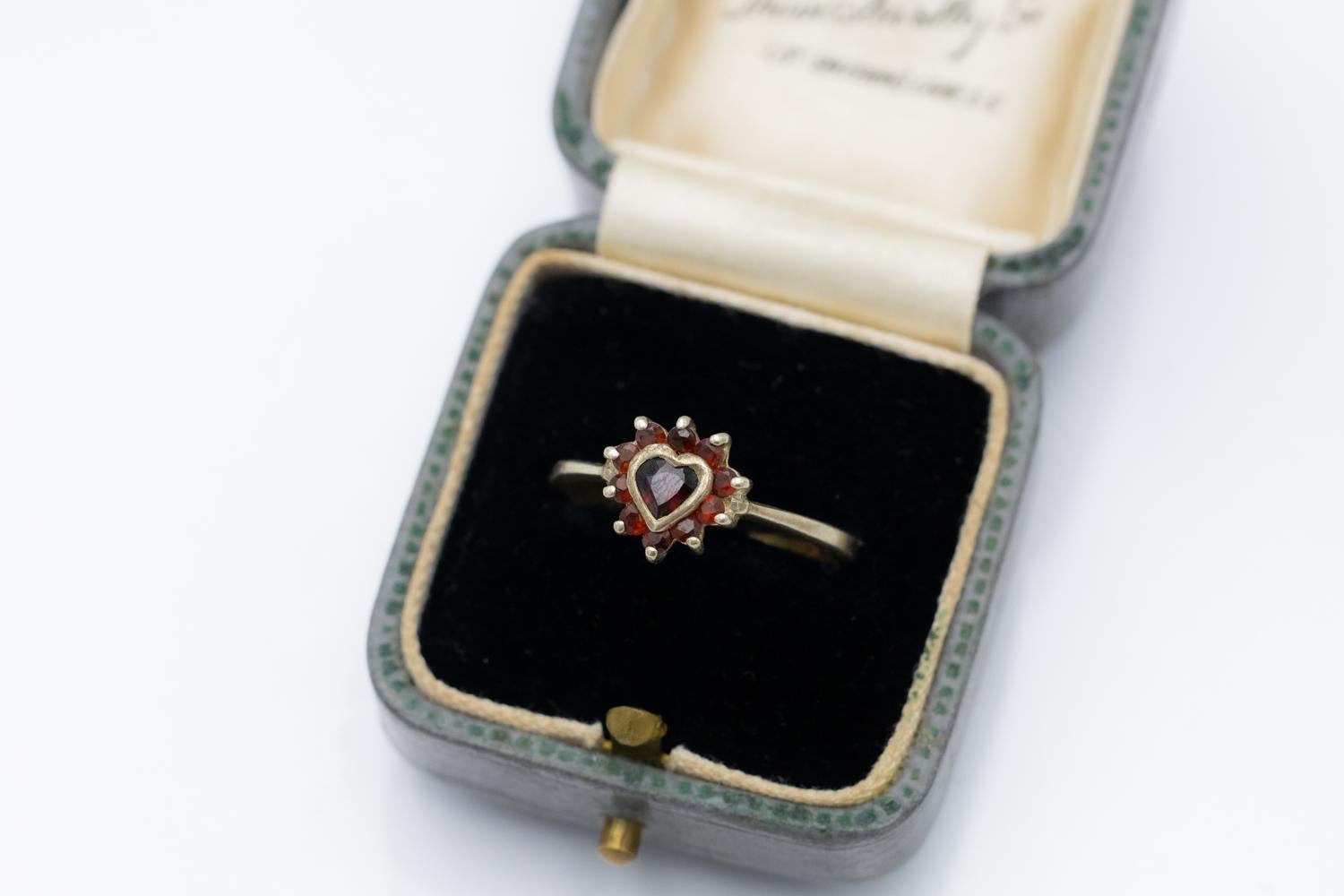 Gold-plated vintage ring in a refined form, set with natural garnets creating a heart motif

Jeweler's size: 15 - no size adjustment possible.

Weight: 2.6g

Origin: Germany, second half of the 20th century.

Very good condition, no damage.