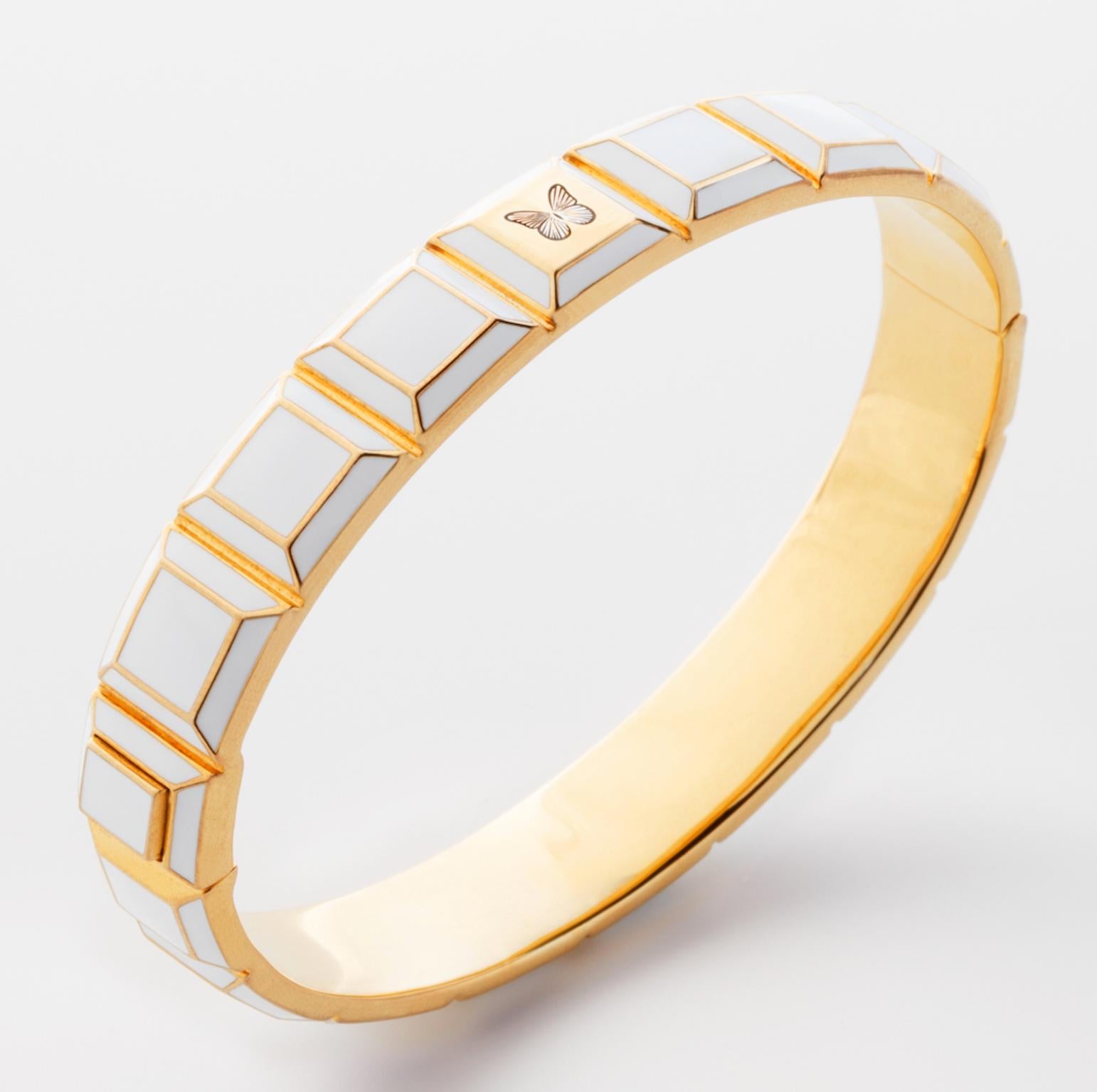 Gold-Plated Enamel Carousel Bracelet features a Yellow Gold Plated Silver bracelet with white enamel and butterfly engraving, along with a clasp closure that secures the bracelet onto the wearer's wrist. 
Yellow Gold Plated Silver, White