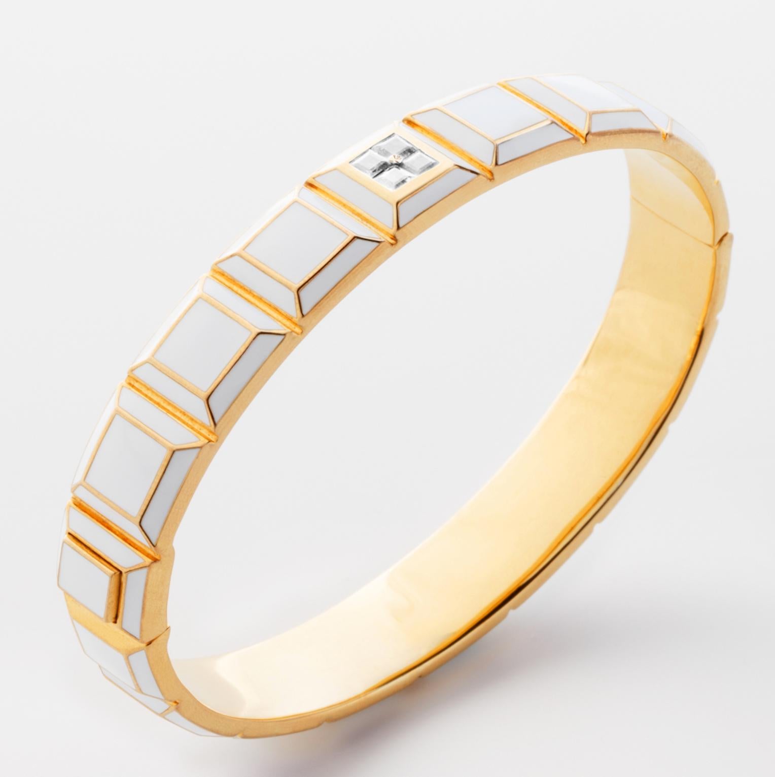 Gold-Plated Enamel Carousel Bracelet features a Yellow Gold-Plated Silver bracelet with white enamel and white sapphires, along with a clasp closure that secures the bracelet onto the wearer's wrist. 
Yellow Gold-Plated Silver, White Enamel, White