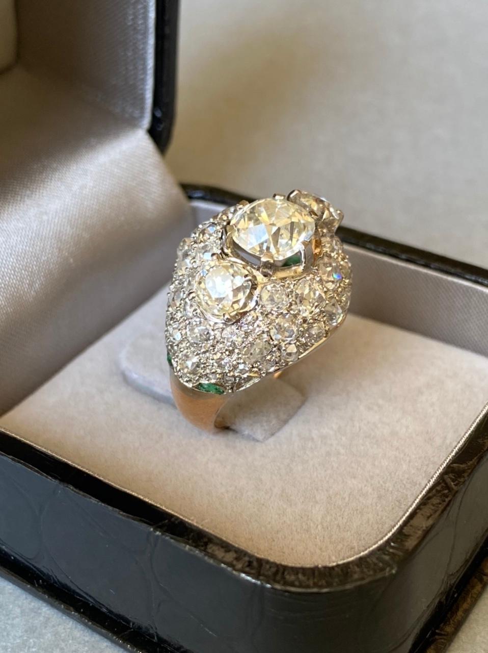 Very beautiful ring, made in France circa 1940/1950. 

Made in yellow gold 18k and platinum. Marks for gold: the Owl, marks for platinum (the old man).
The diamonds are old European cut, they are good quality. The central diamonds weights 1.91