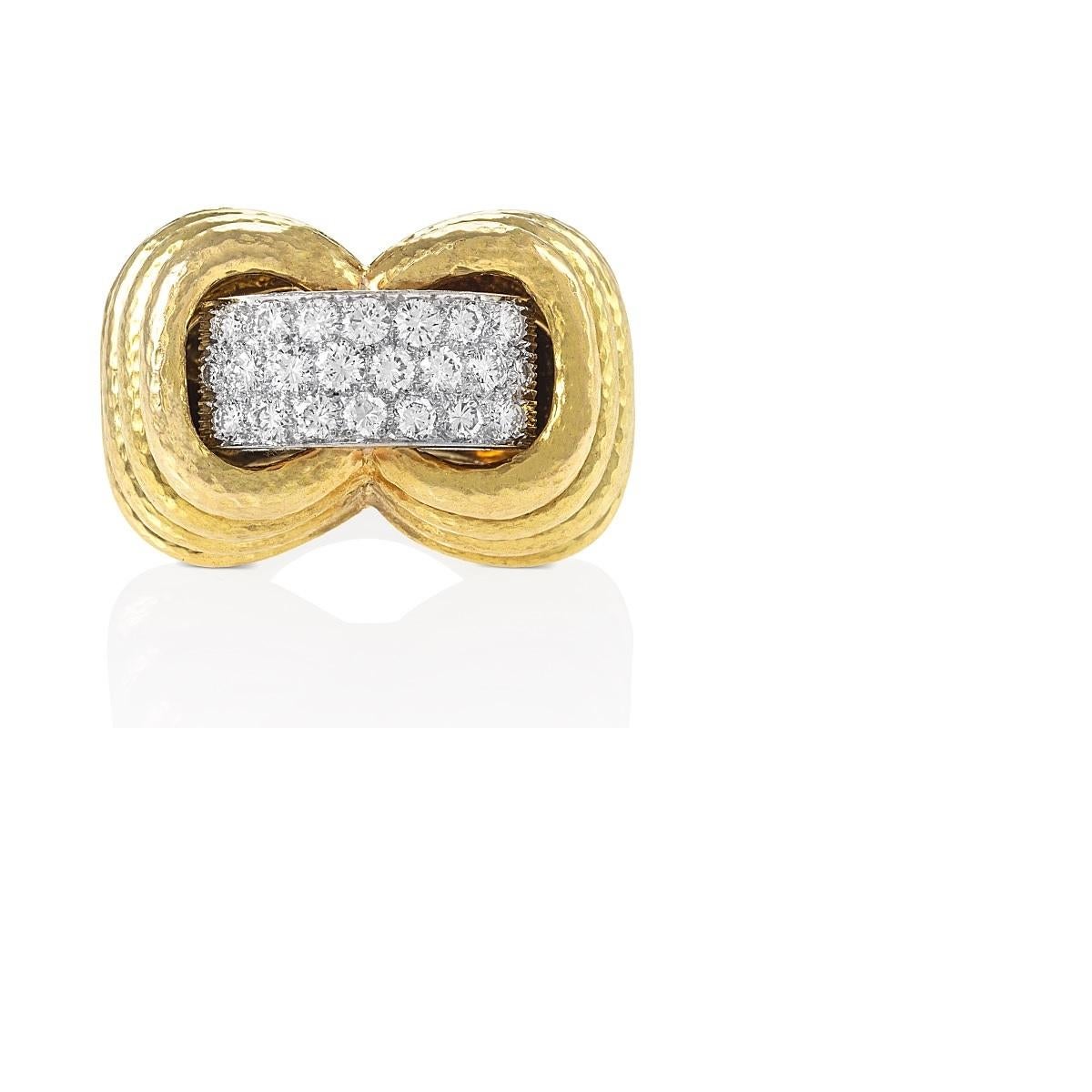 An 18 karat gold, platinum and diamond ring, by David Webb. The hammered bombé form mount with stepped sides centers a band of 21 round brilliant-cut diamonds, approximate total weight 2.15 carats, with a F/G color and VS clarity.  
Size 5-3/4

This