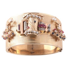 Gold Platinum Diamond And Colored Stone Charm Bangle-Bracelet Circa 1940