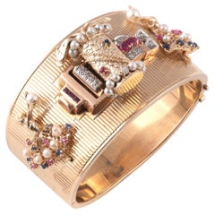 Gold Platinum Diamond And Colored Stone Charm Bangle-Bracelet Circa 1940