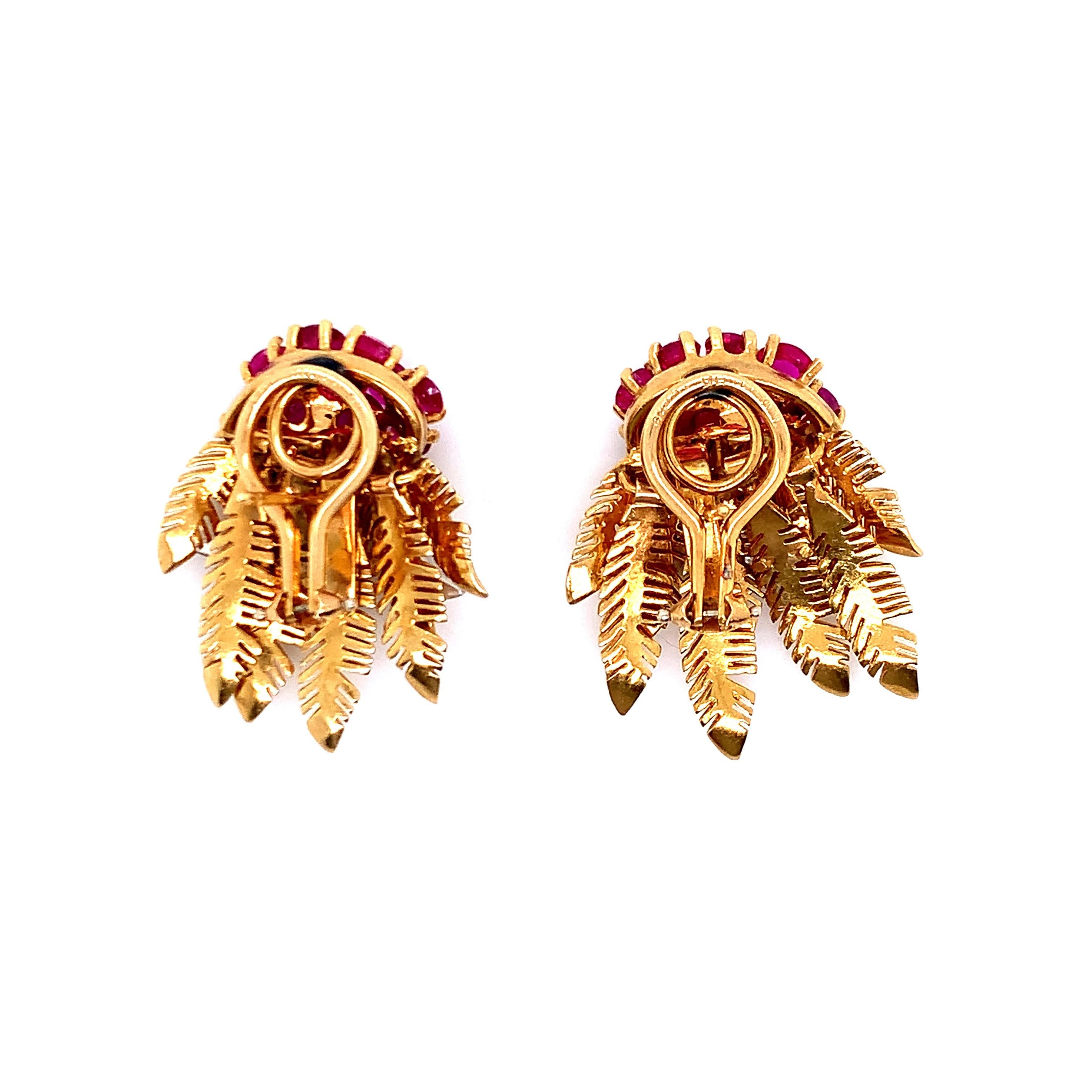 A pair of rubies and diamonds set on gold and platinum ear clips with leaf motif. There are 20 round rubies, weighing approximately 4.00 carats and 30 round diamonds, weighing approximately 0.70 carat. The lower movable leaves are movable. Total