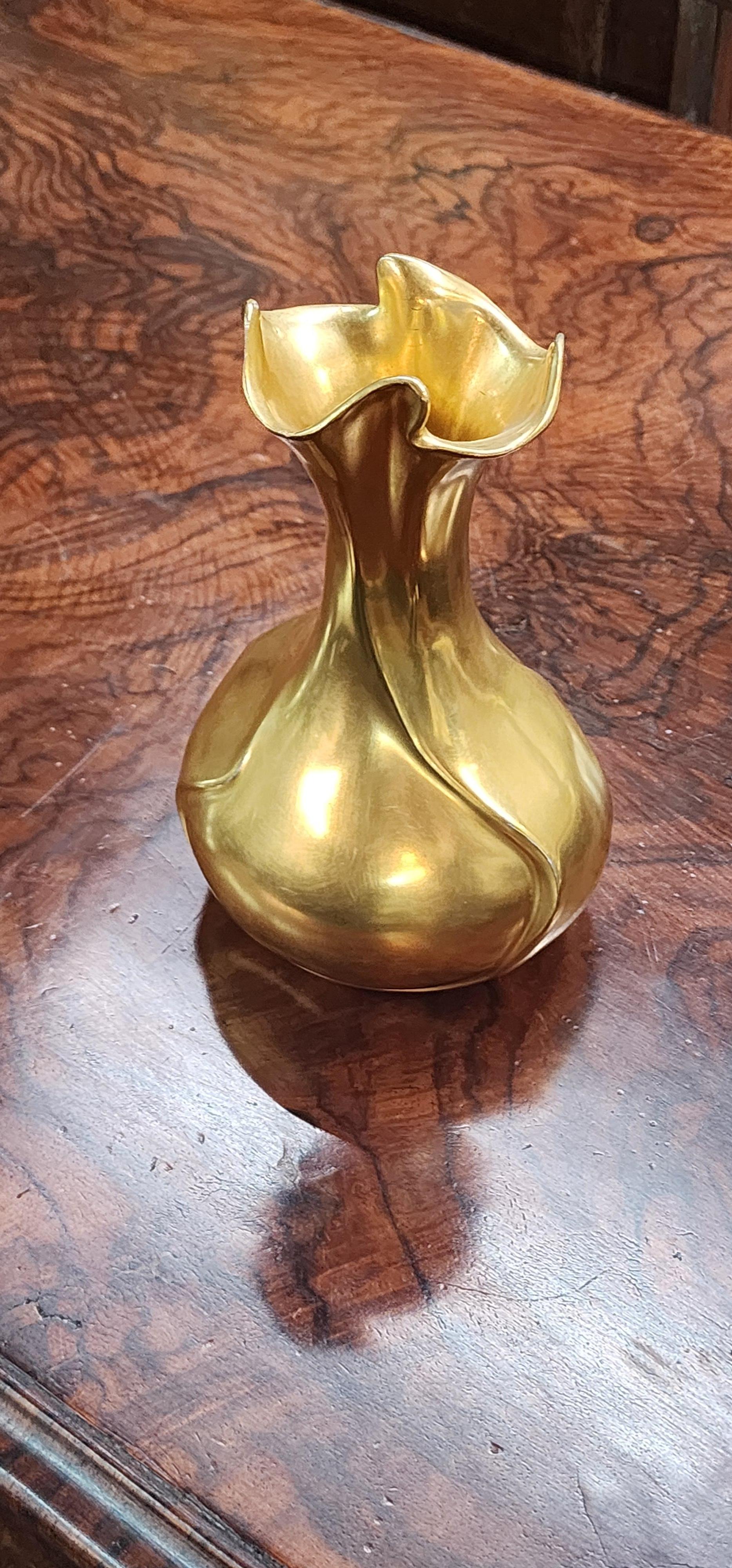  Art Nouveau style vase in gold porcelain with flowing swirled shape wrapping around to bulb base and up to flared top. Circa 1910 