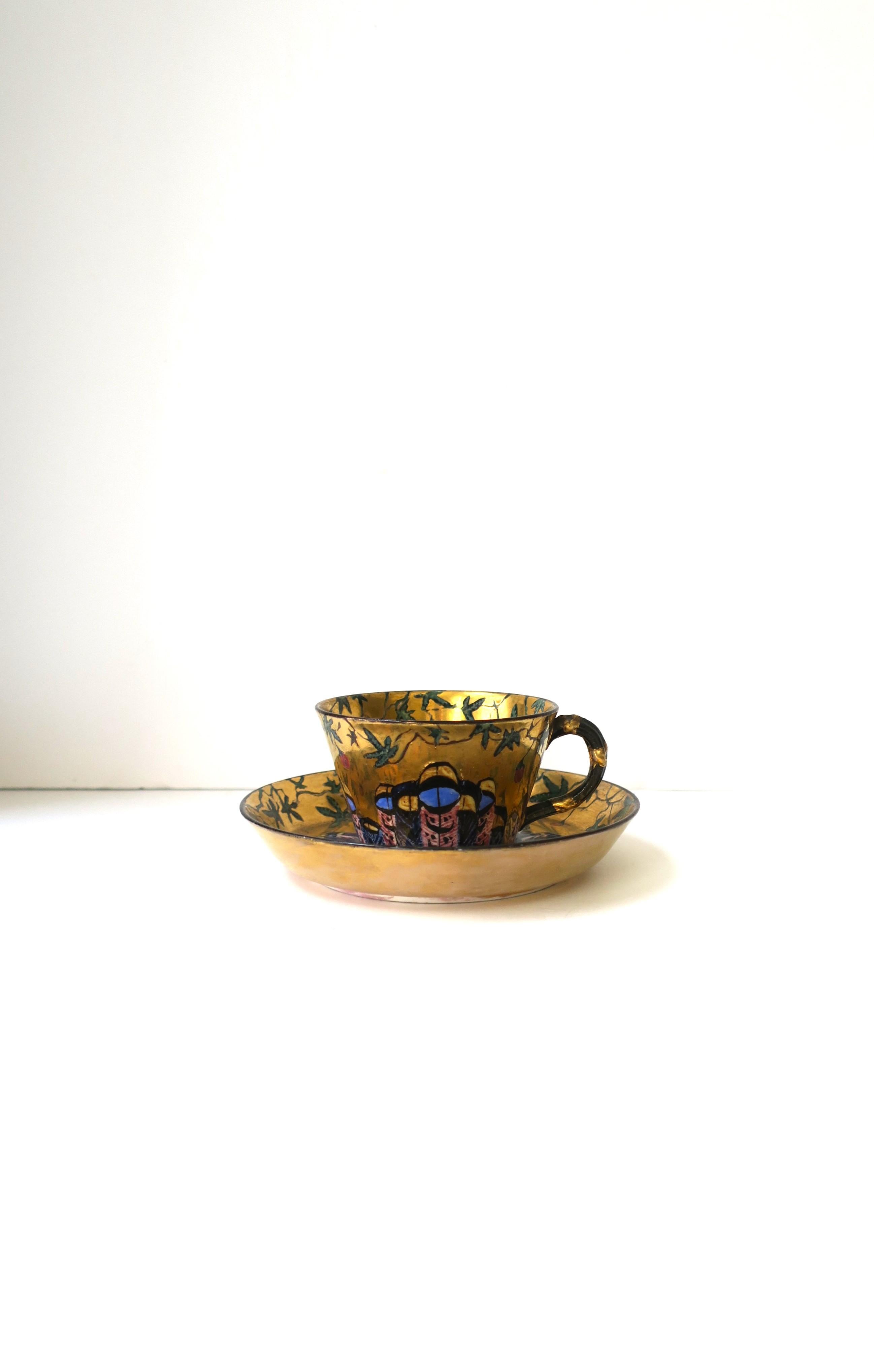 A very beautiful and special porcelain coffee or tea cup and saucer, circa early to mid-20th century. Maybe French or Italian origin. Designer unknow. Both cup and saucer are all-around gold. Saucer has beautiful green leaf and red flower bud design