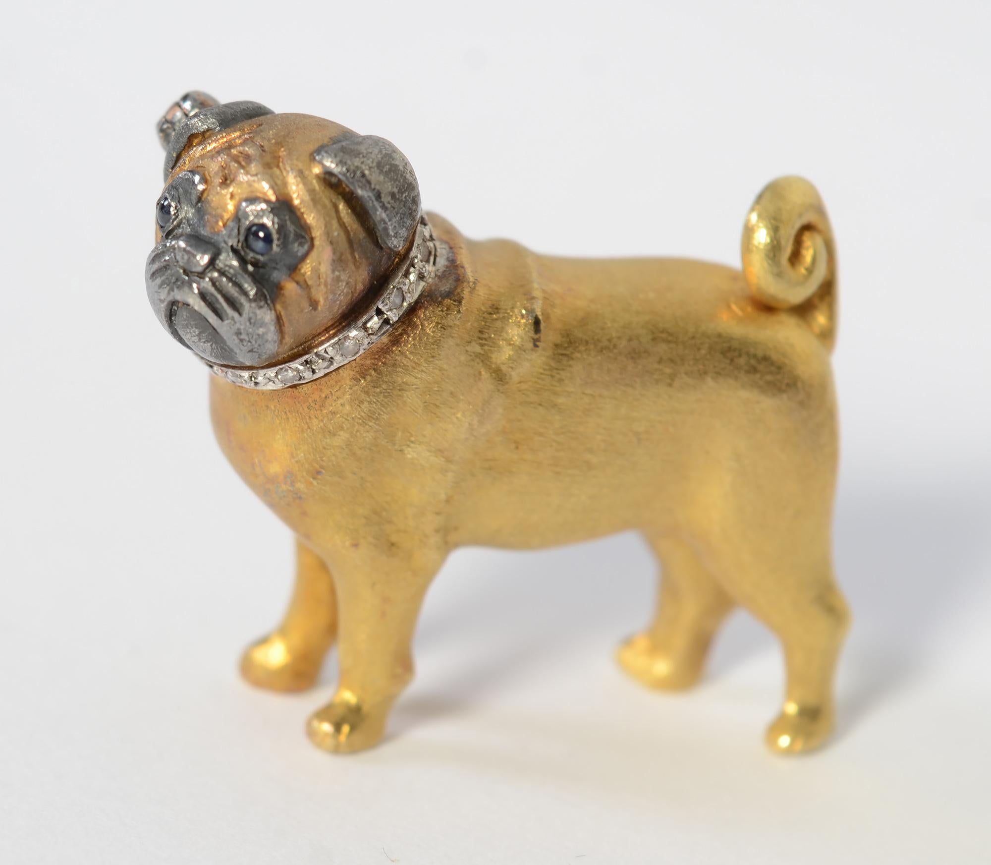 This beautifully made Pug brooch is as solid as the breed itself. It is wonderfully textured and detailed. The protruding eyes appear to be sapphires. The ears and snout are blackened. The brooch has English hallmarks and a maker's mark with which I
