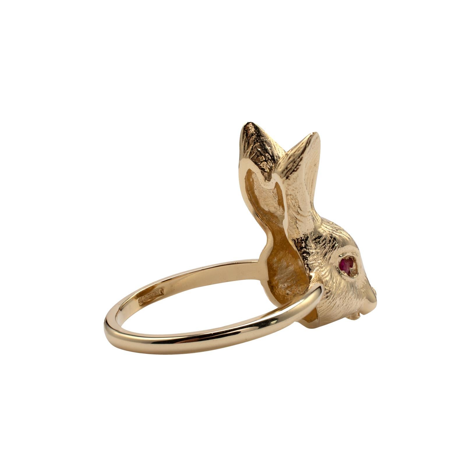 This adorable solid gold Rabbit ring, set with ruby gemstone eyes is custom made to order in any ring size. 

The example shown is made in 9 karat yellow gold and features ruby eyes and weighs 4.5 grams.

The cute bunny rabbit ring is substantial in