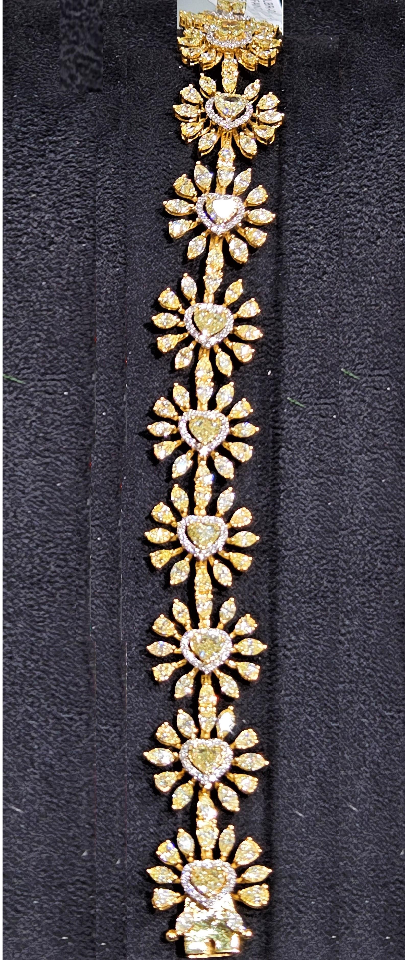 The Following Item we are offering is this Beautiful Rare Important Gold Large Glittering Heart Diamond Tennis Bracelet. Bracelet is comprised of approx 15CTS Magnificent Rare Gorgeous Fancy Glittering Heart Shaped Yellow Diamonds each surrounded