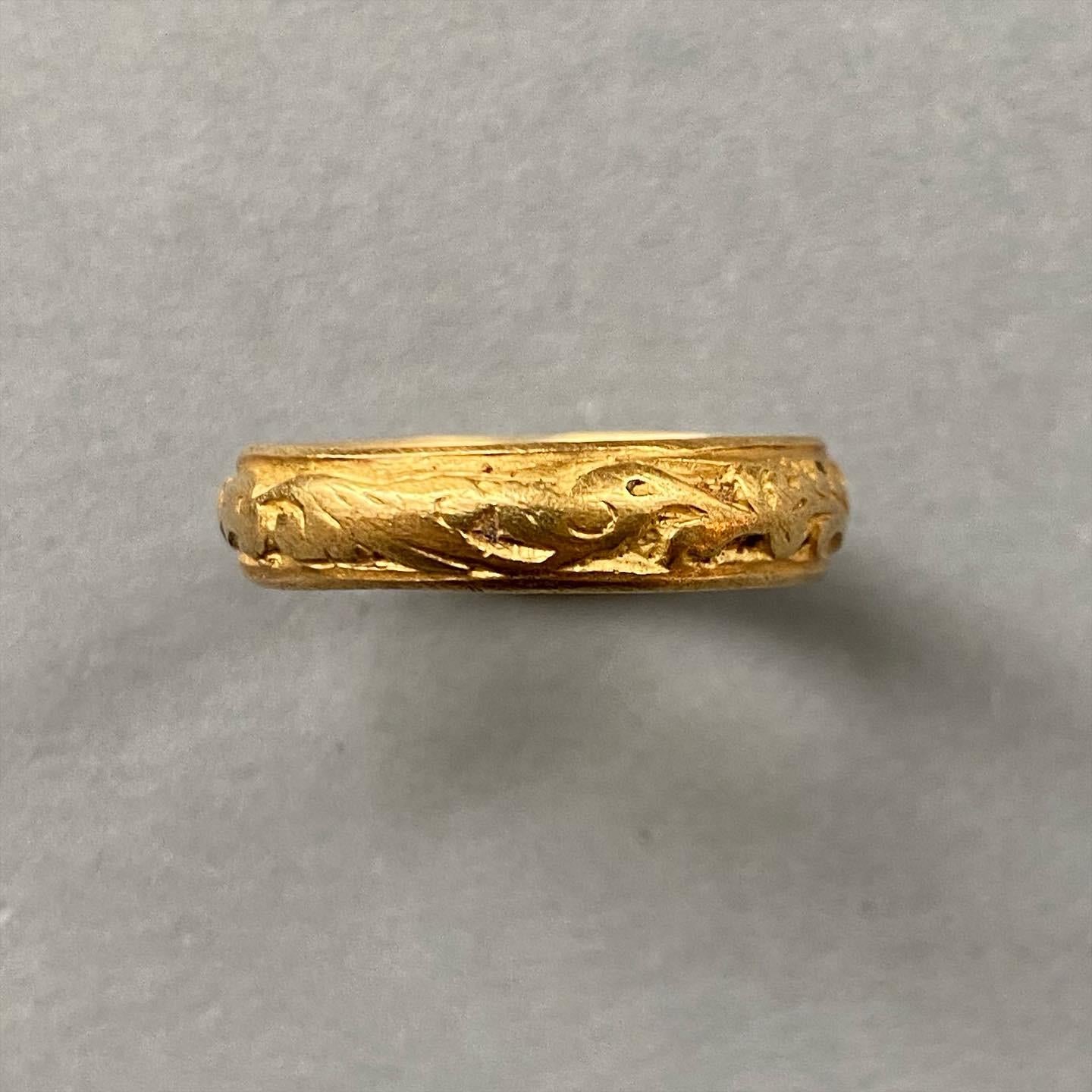 A rare early gold ring fully decorated with foliate ornaments and a bird!  lacking its original champlevé enamel except for a few tiny black spots, Western European, 1st quarter of the 17th century. Found in the Netherlands and registered with