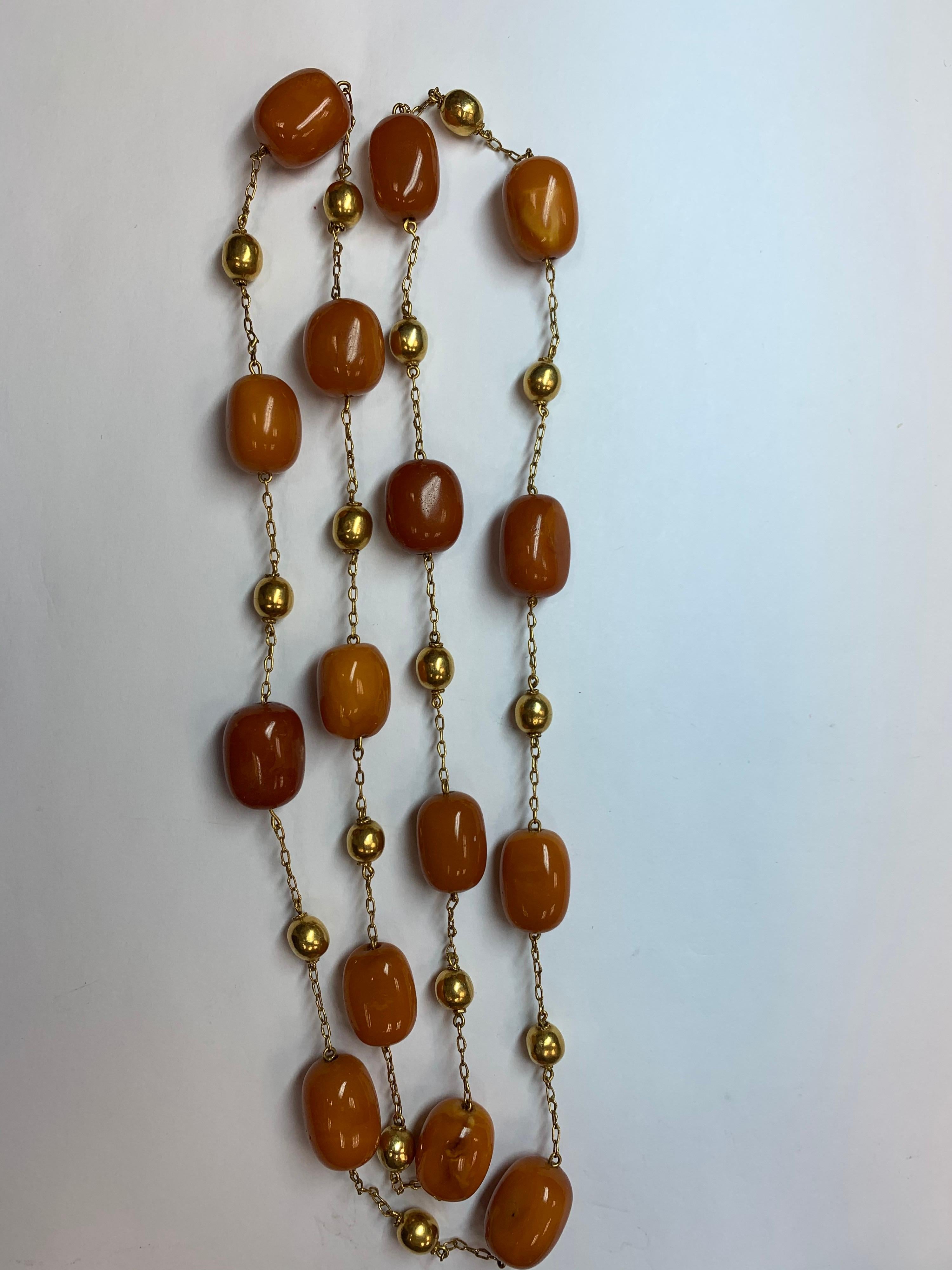 Oval Cut Gold Retro Natural Butterscotch Egg Yolk Amber Gem Necklace Bead, circa 1950 For Sale