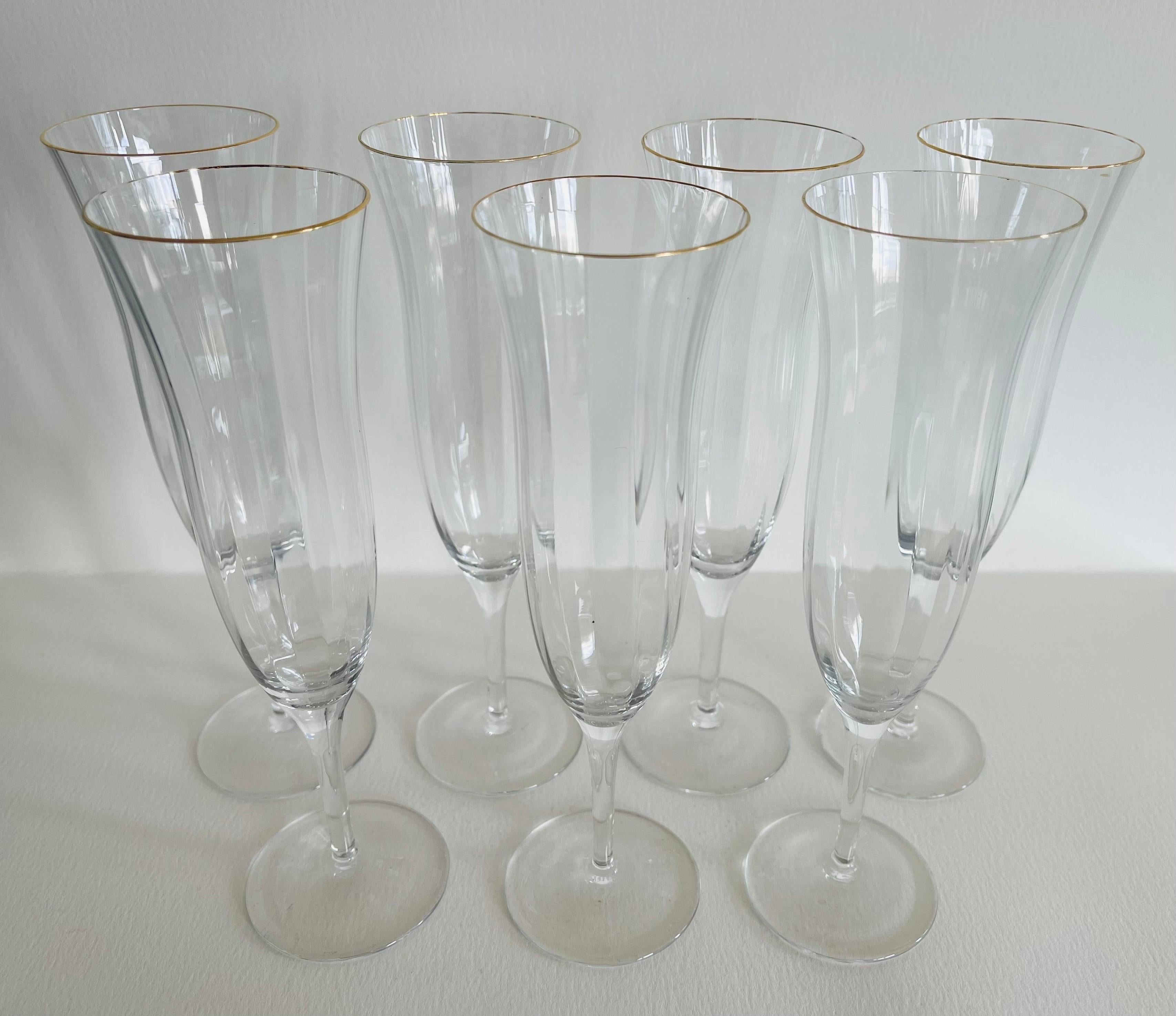 Vintage set of seven gold rim champagne glass flutes. Marked Gorham.