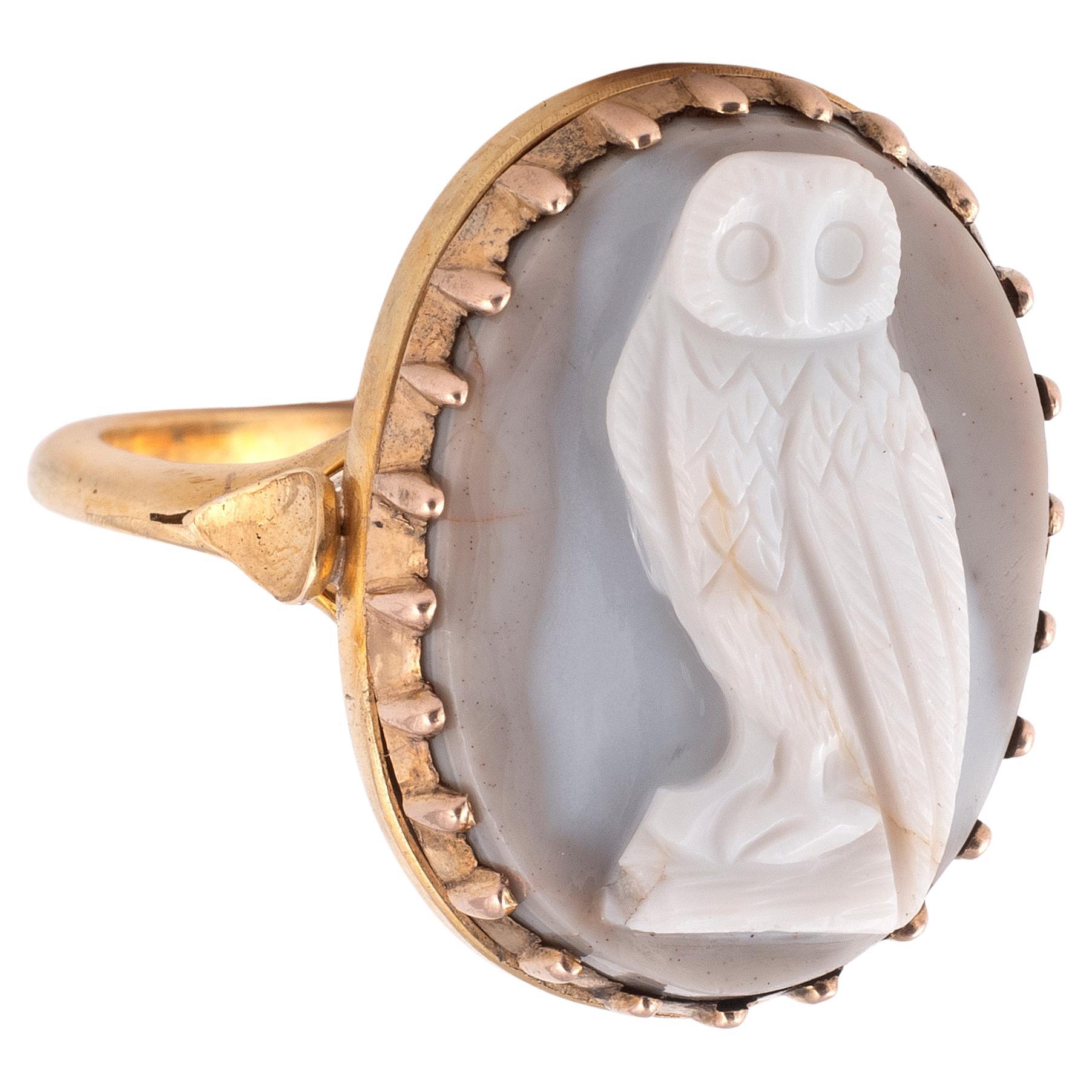 A hardstone white agate cameo depicting the owl in gold collet settings.
The size cameo is 1.9 x 1.4cm
Size 7
Weight: 6.8gr.

Another owl cameo was sold by Sotheby’s Bond Street, 06 December 2016; Old Master Sculpture and Works of Art Including
