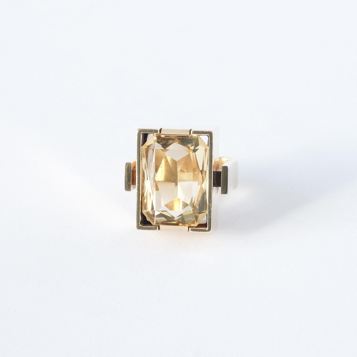 This 14 karat gold ring has a large, octagonal cut citrine which is placed in a rectangular chest shaped setting. The ring's wide and prominent shaft gives it a luxurious and interesting appearance.

The ring radiates strength and attitude and is