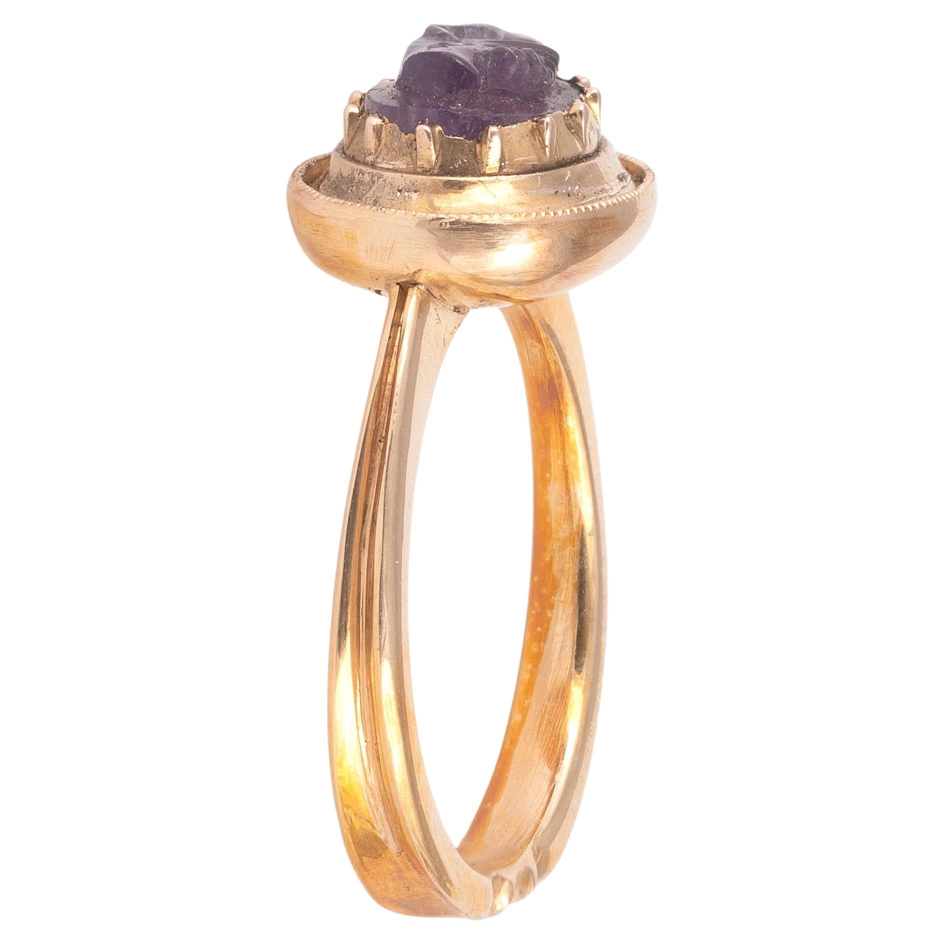 A cameo a pair of clasped hands in amethyst in gold collet settings.
The size cameo is 11mm x 9mm
Size 7 1/2
Weight: 5.31gr.
The clasping of the right hands of a betrothed couple was a gesture of loyalty and mutual accord, following the agreement of