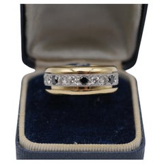 Goldring aus Gold mit drehbarem Weißgoldband und schwarz-weißen Diamanten