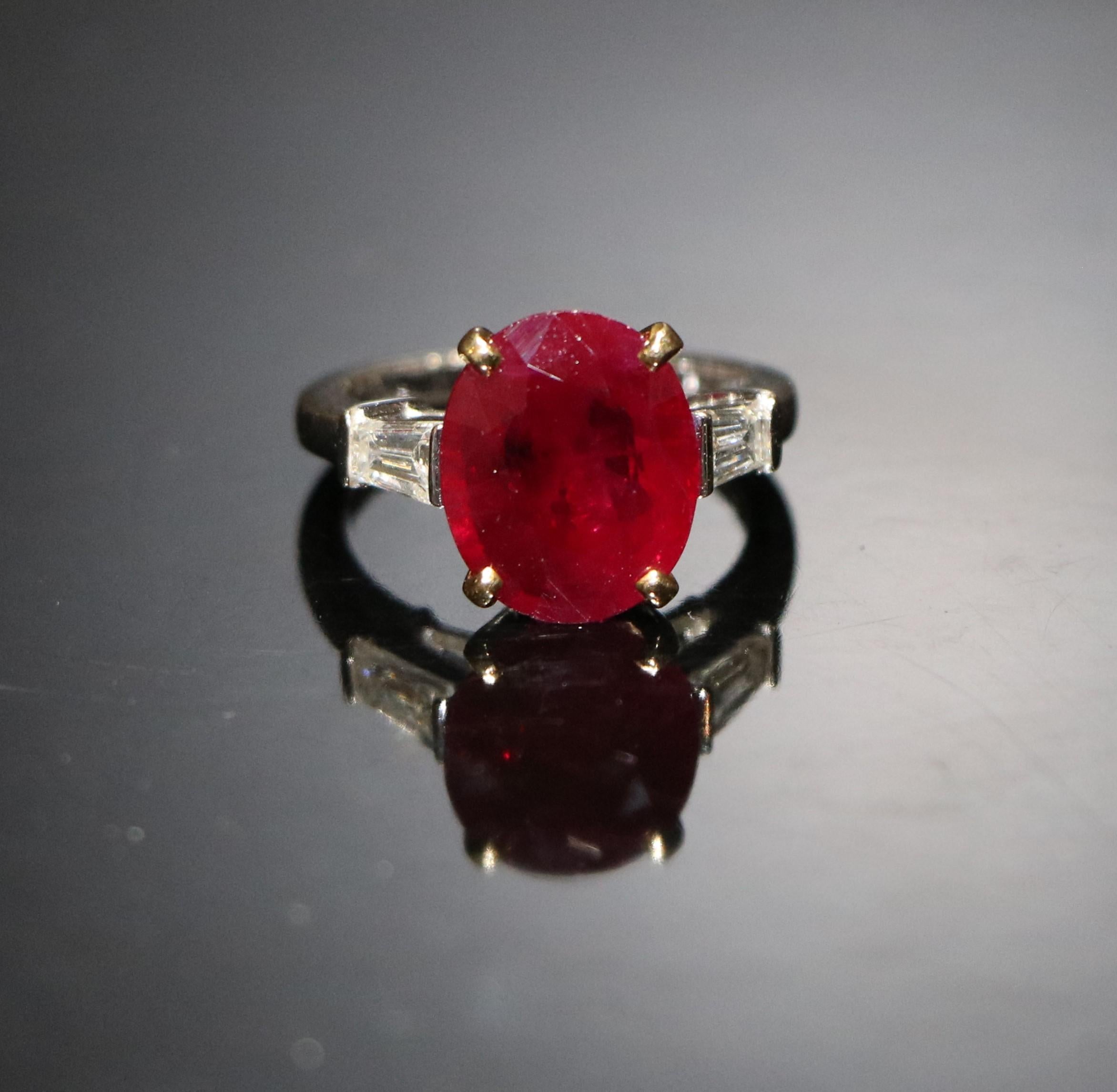 Gold Ring with ruby ​​and diamonds

White Gold 18 karat

Side stones: Baguette-cut diamonds

Ruby Stone Details:
Shape: Oval
Cutting Style: Brilliant Cut (Crown), Step Cut (Pavilion)
Transparency: Transparent
Color: Vivid Red
Species: Natural