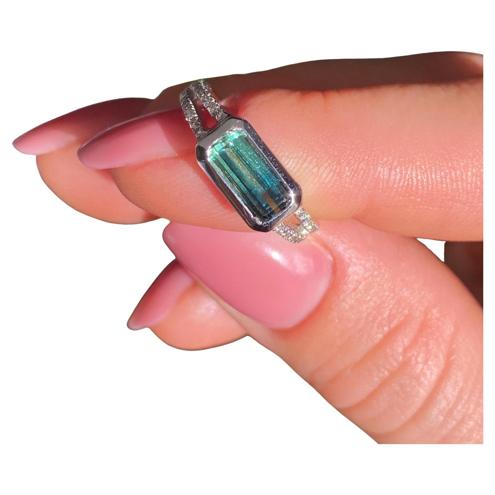 Natural Tourmaline and Diamonds gems
Solid 14 Karat White Gold Ring

Laboratory full certificate for the ring.
Main Stone: Tourmaline 1.6ct
Main Stone Creation: Natural
Main Stone Color: Bluish-Yellowish Green
Main Stone Origin: Afghanistan
Main