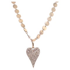 Chaîne à disques ronds en or avec pendentif cœur en diamants