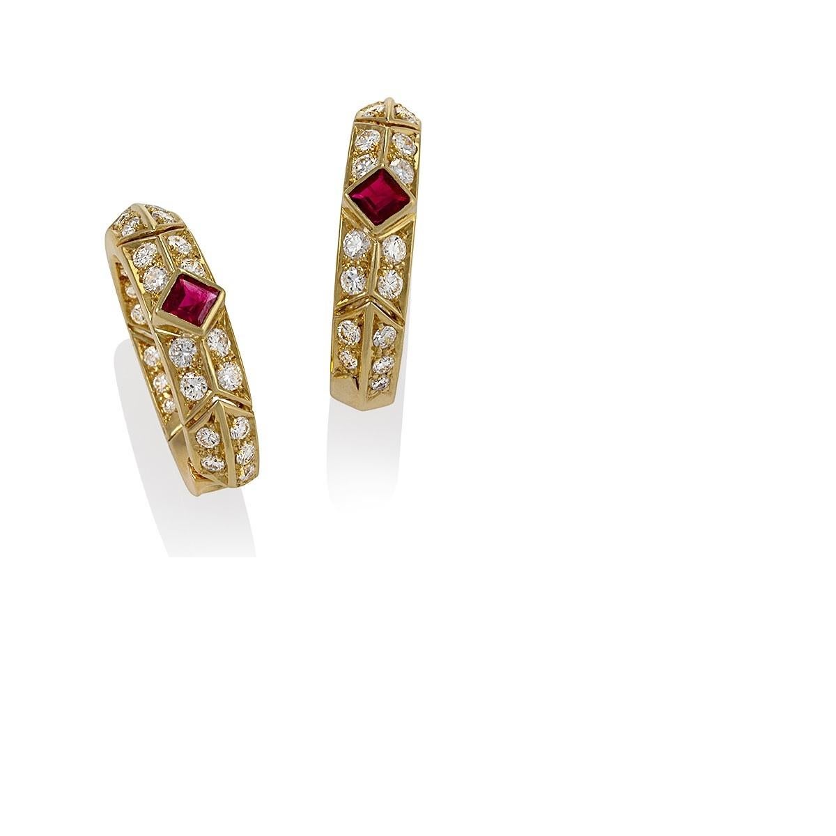 A pair of French 18 karat gold hoop earrings with rubies and diamonds by Van Cleef & Arpels. The hoop earrings have 2 square cut rubes with an approximate total weight of .80 carats, and 60 round cut diamonds with an approximate total weight of 1.40