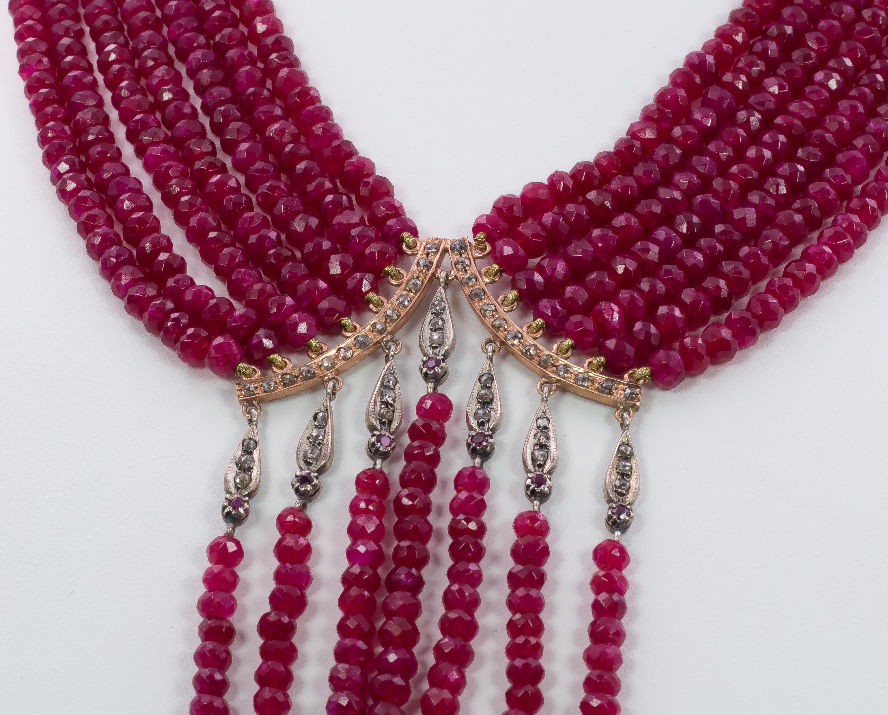 This stunning and elegant necklace is set with multi strands, each one set with rubies; seven pendant strands create a beautiful movement to this collier. The gold settings are ornamented with rose cut diamonds. 

MATERIALS
Gold, ruby and rose cut